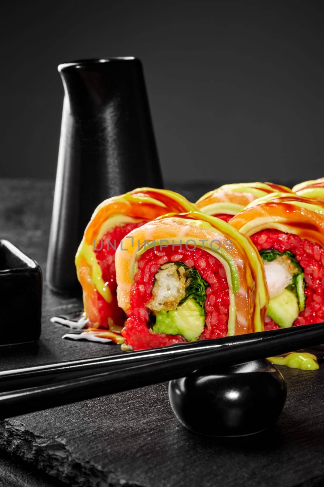 Enticing salmon sushi roll with shrimp tempura and sauces by nazarovsergey