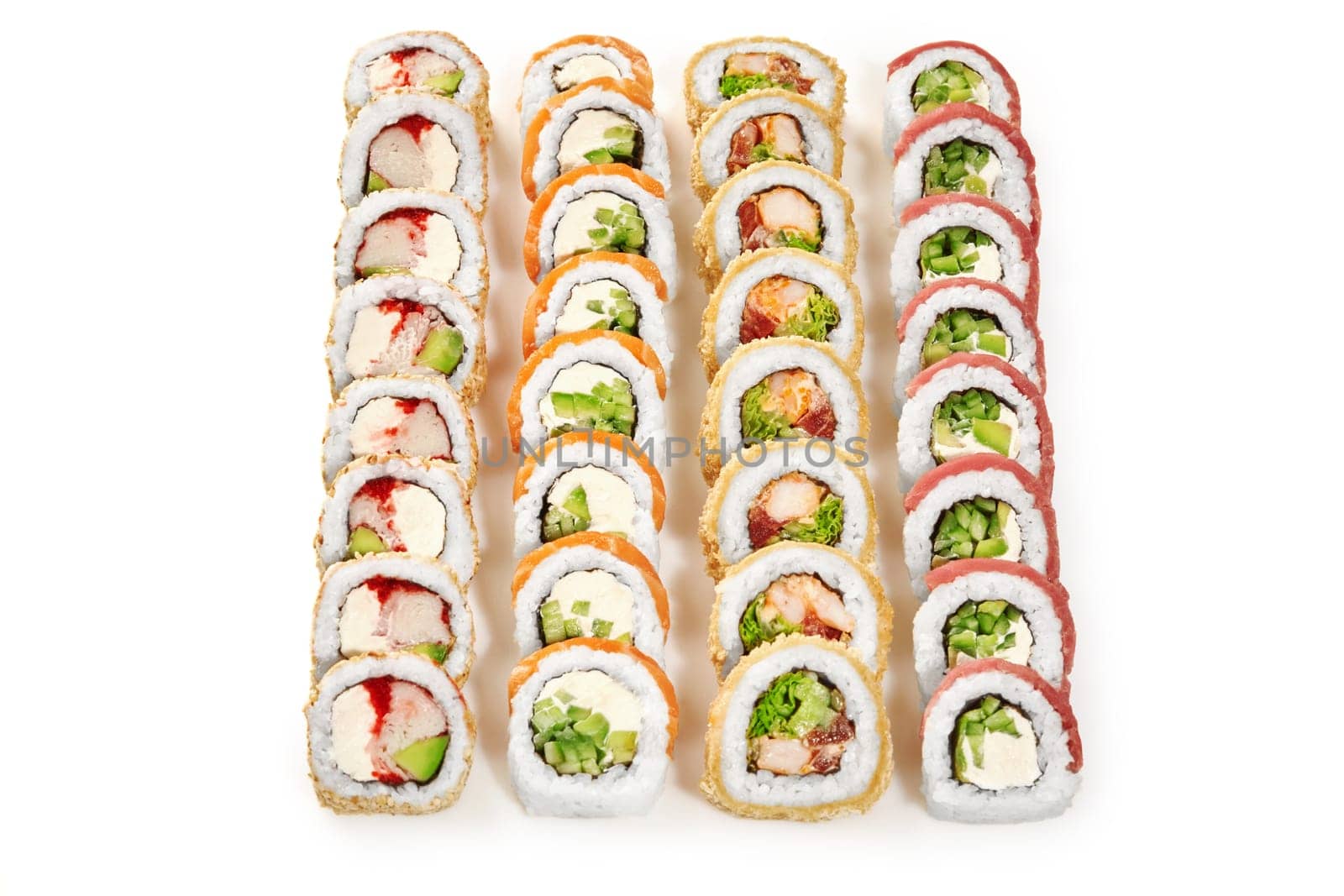 Light snacks for Japanese themed party. Colorful set featuring tempura roll with shrimp, uramaki in sesame with crab and tobiko, Philadelphia rolls with tuna and salmon, isolated on white