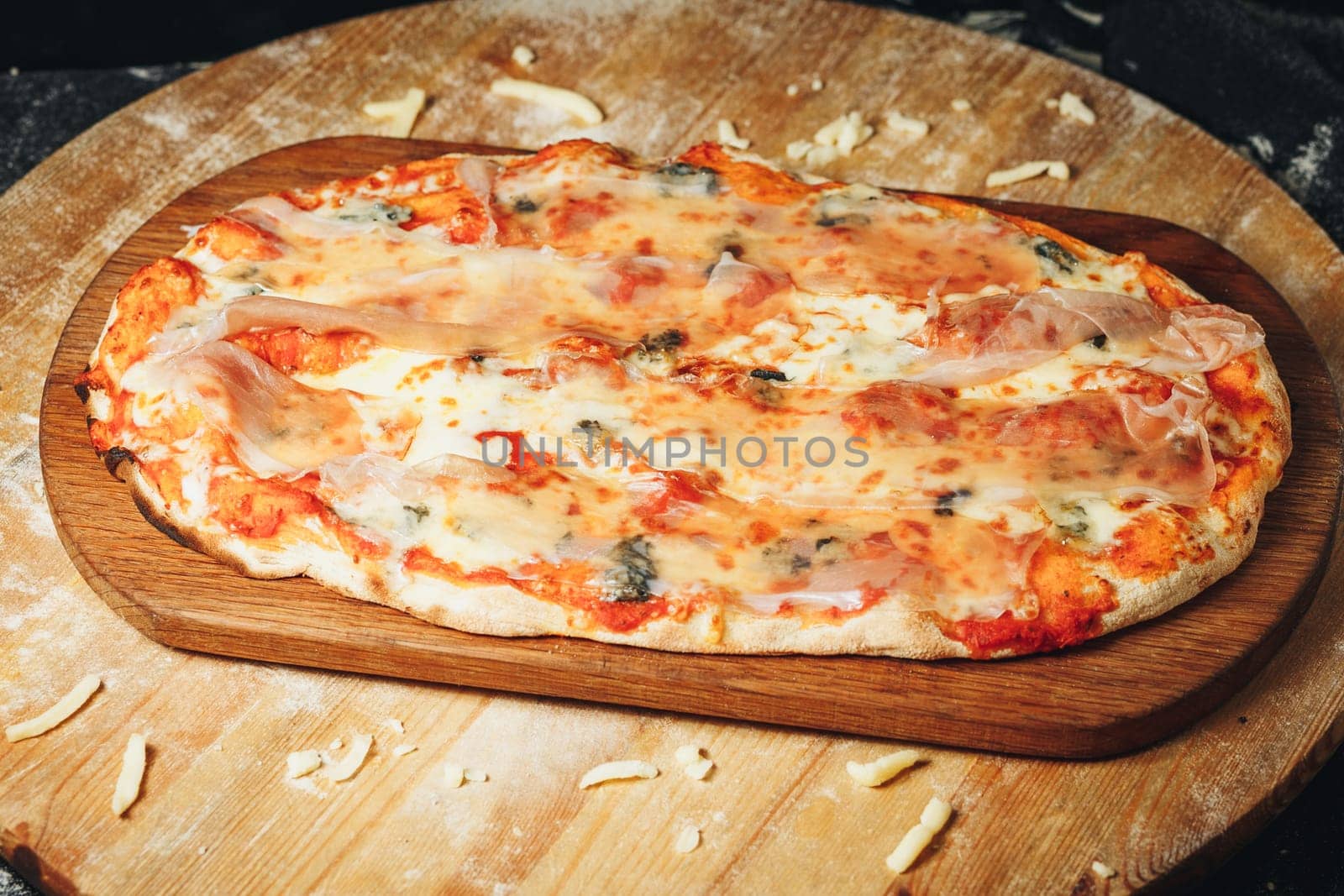 A freshly baked pizza sitting on a rustic wooden cutting board, with steam rising from the golden crust and cheese.