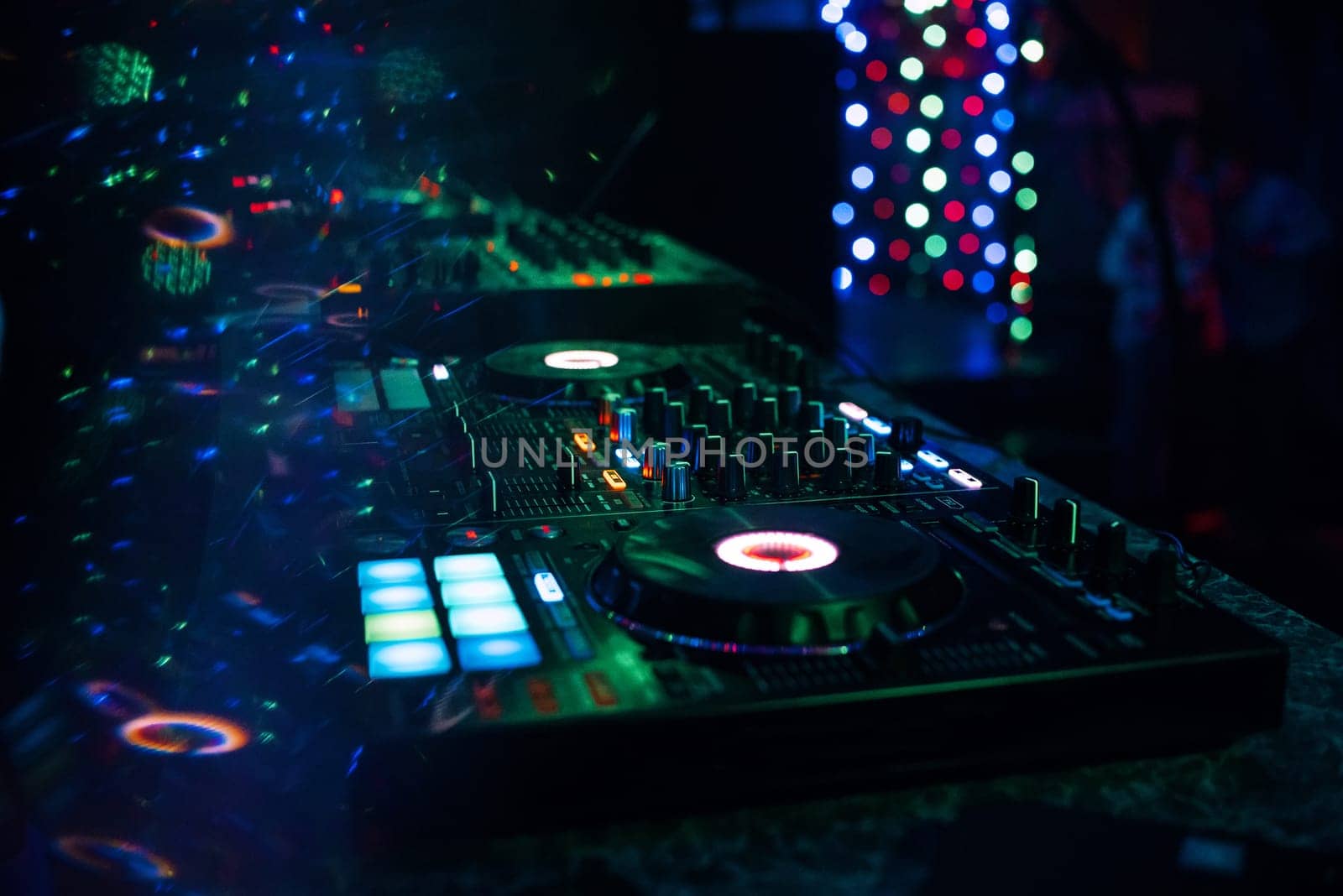 music mixer DJ controller Board for professional mixing of electronic music in a nightclub at a party