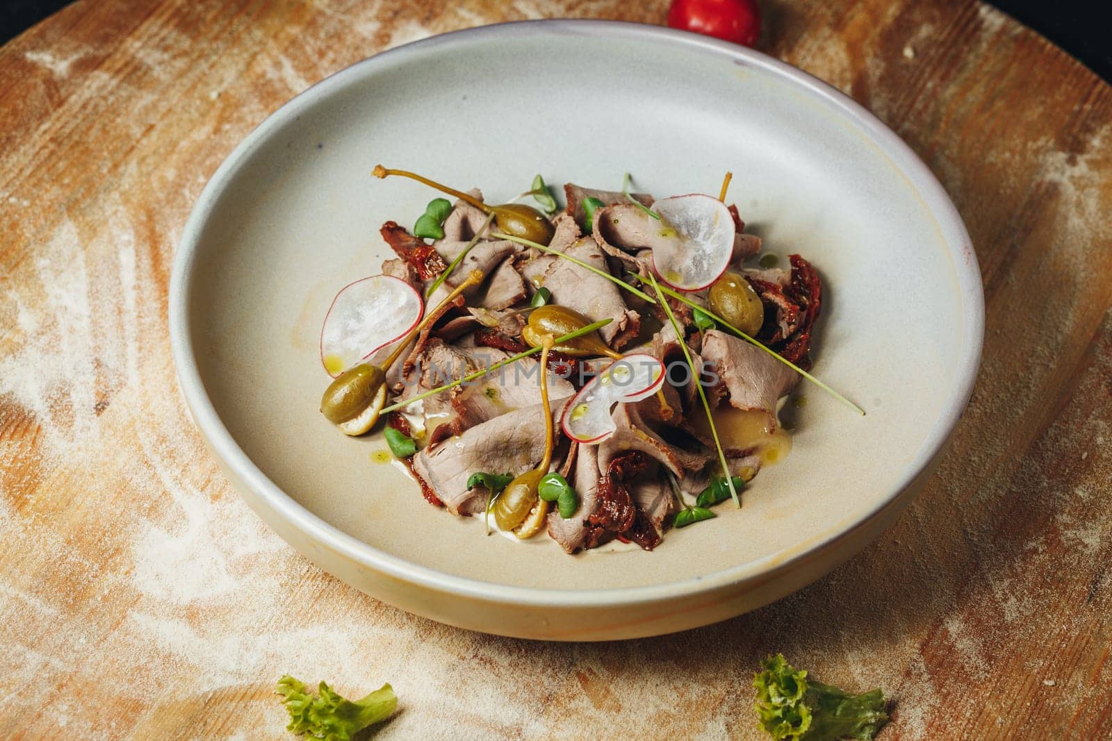 A bowl filled with delicious food rests on a wooden table, exuding warmth and comfort in its rustic setting.