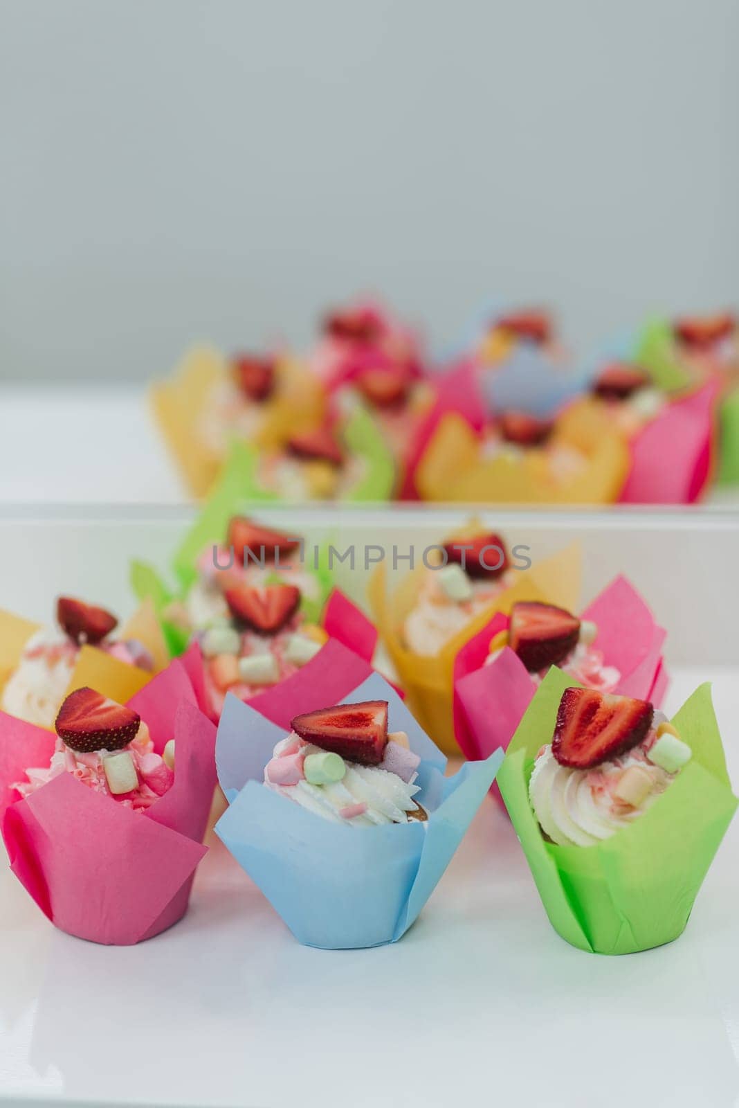 sweet cupcakes muffins with fresh strawberries and white cream for Valentine's day