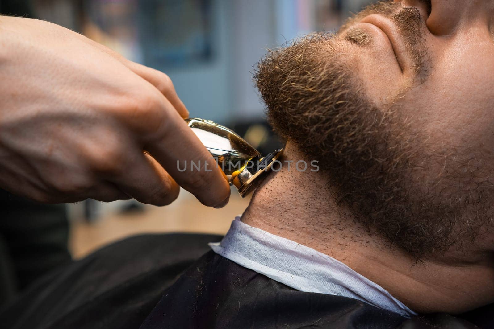 Stylist cuts hair on neck creating beard shape for man by vladimka