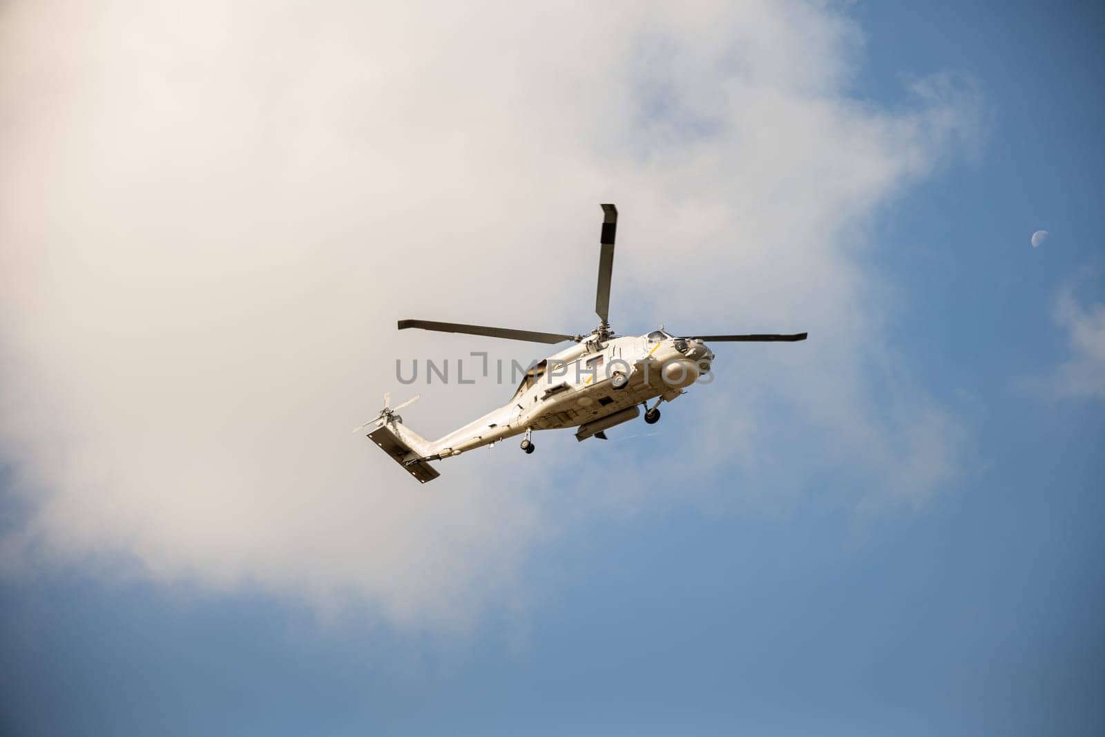 Modern helicopter in flight against blue sky. New engine technology for rescue and transport. Pilot maneuvers small aircraft with speed and precision showcasing hovering capability.