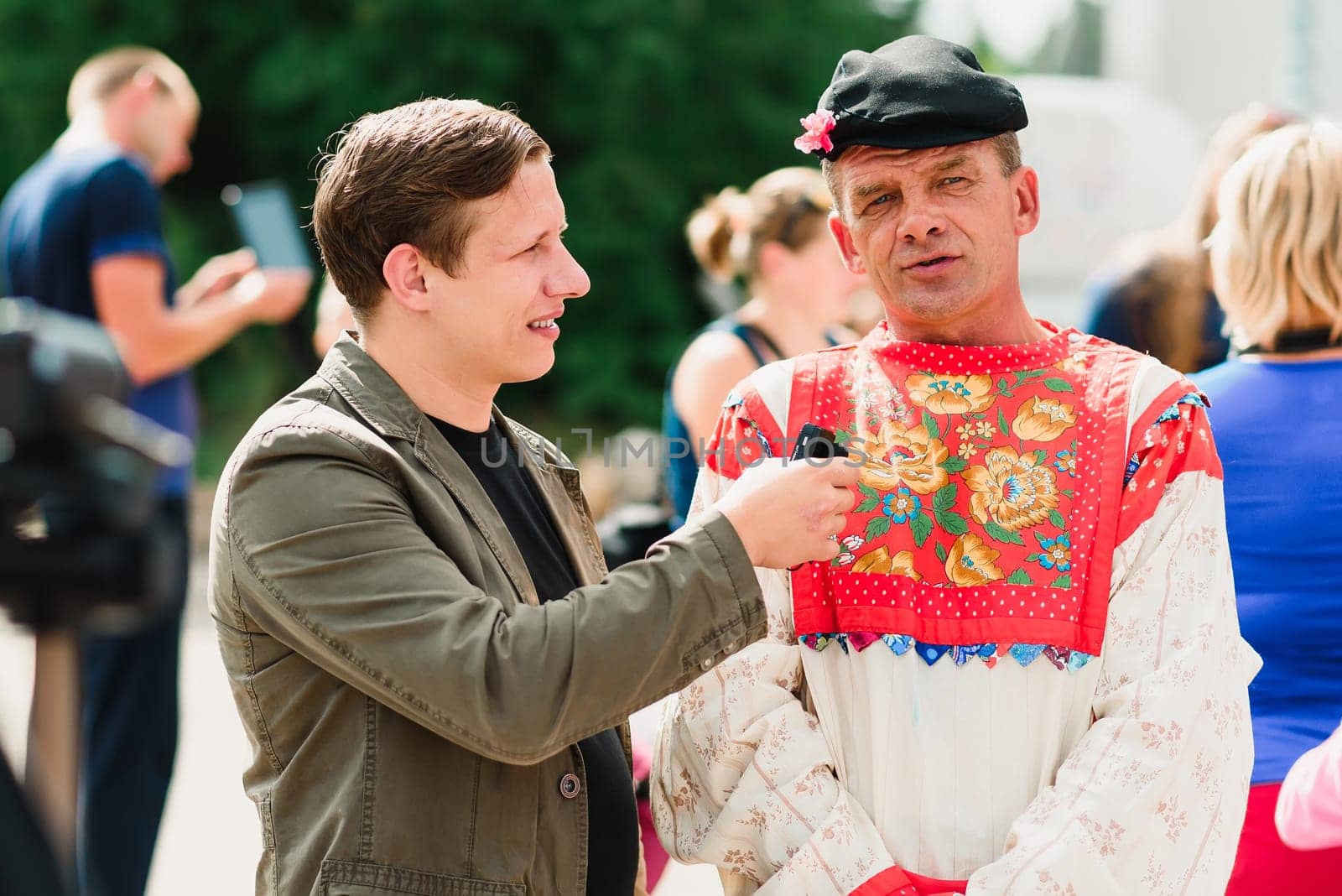 LUH, RUSSIA - AUGUST 27, 2016: reporter interviews a man at a holiday festival