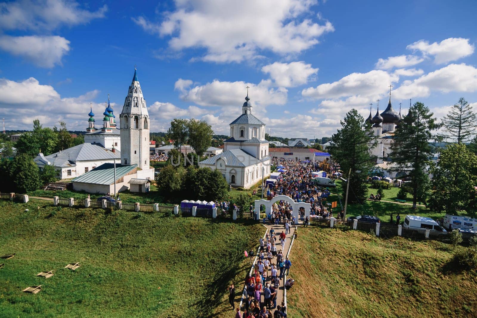 LUH, RUSSIA - AUGUST 27, 2016: Temple ensemble of the village of Luh with tourists on the holiday of Onion day by alexkoral