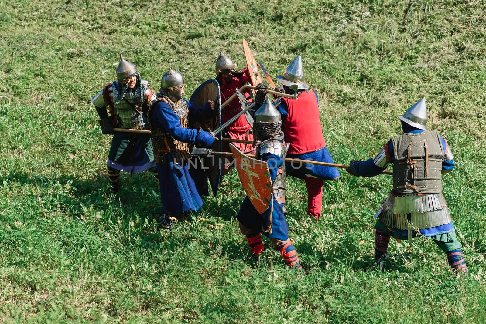 LUH, RUSSIA - AUGUST 27, 2016: Reconstruction of medieval battle of knights in armor and weapons at the festival of Onions in the village of Luh