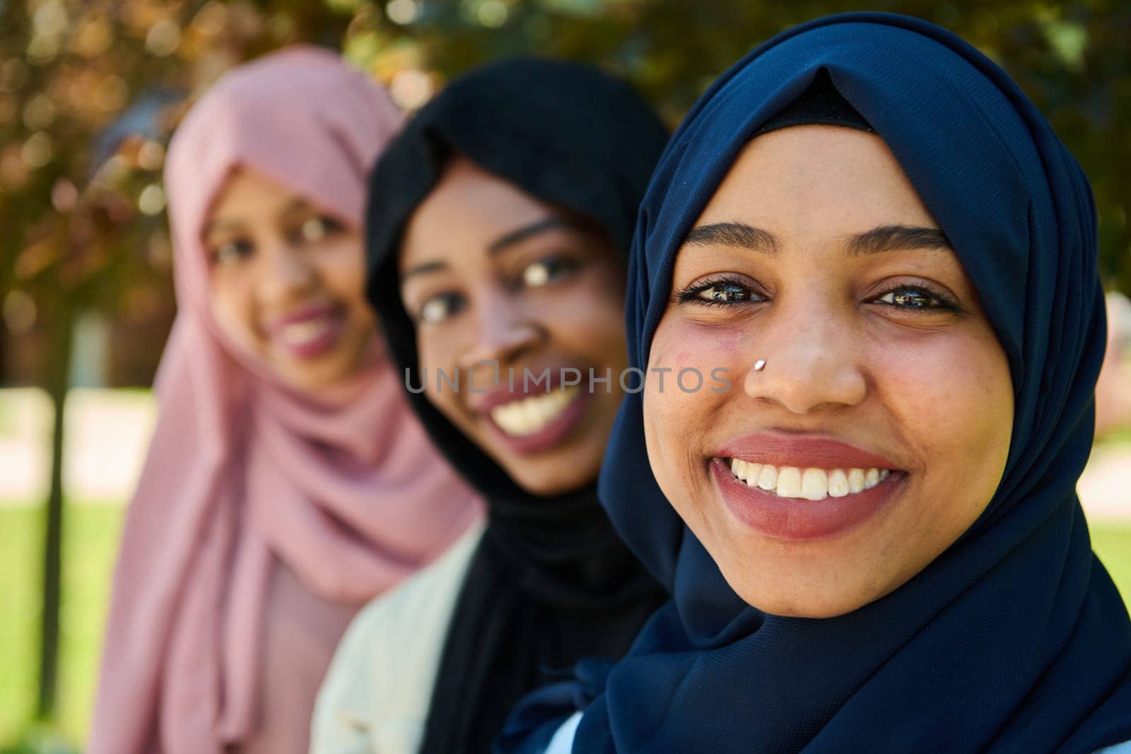 A symbolic portrayal of unity and sisterhood as a group of Middle Eastern Muslim women, wearing hijabs, come together for a collective photograph