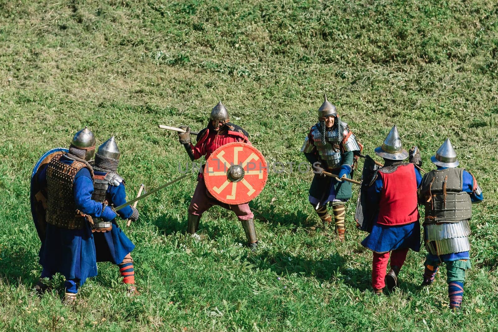 LUH, RUSSIA - AUGUST 27, 2016: Reconstruction of medieval battle of knights in armor and weapons at the festival of Onions in the village of Luh