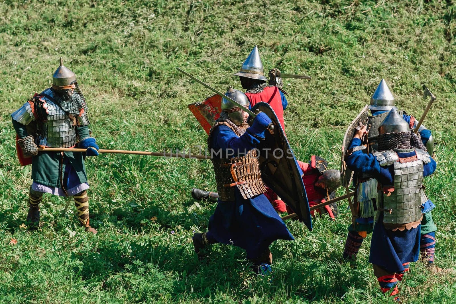 LUH, RUSSIA - AUGUST 27, 2016: Reconstruction of medieval battle of knights in armor and weapons at the festival of Onions in the village of Luh