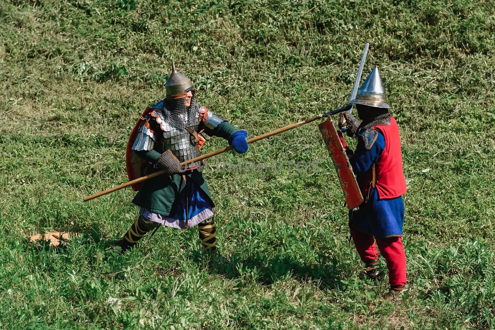 LUH, RUSSIA - AUGUST 27, 2016: Reconstruction of medieval battle of knights in armor and weapons at the festival of Onions in the village of Luh