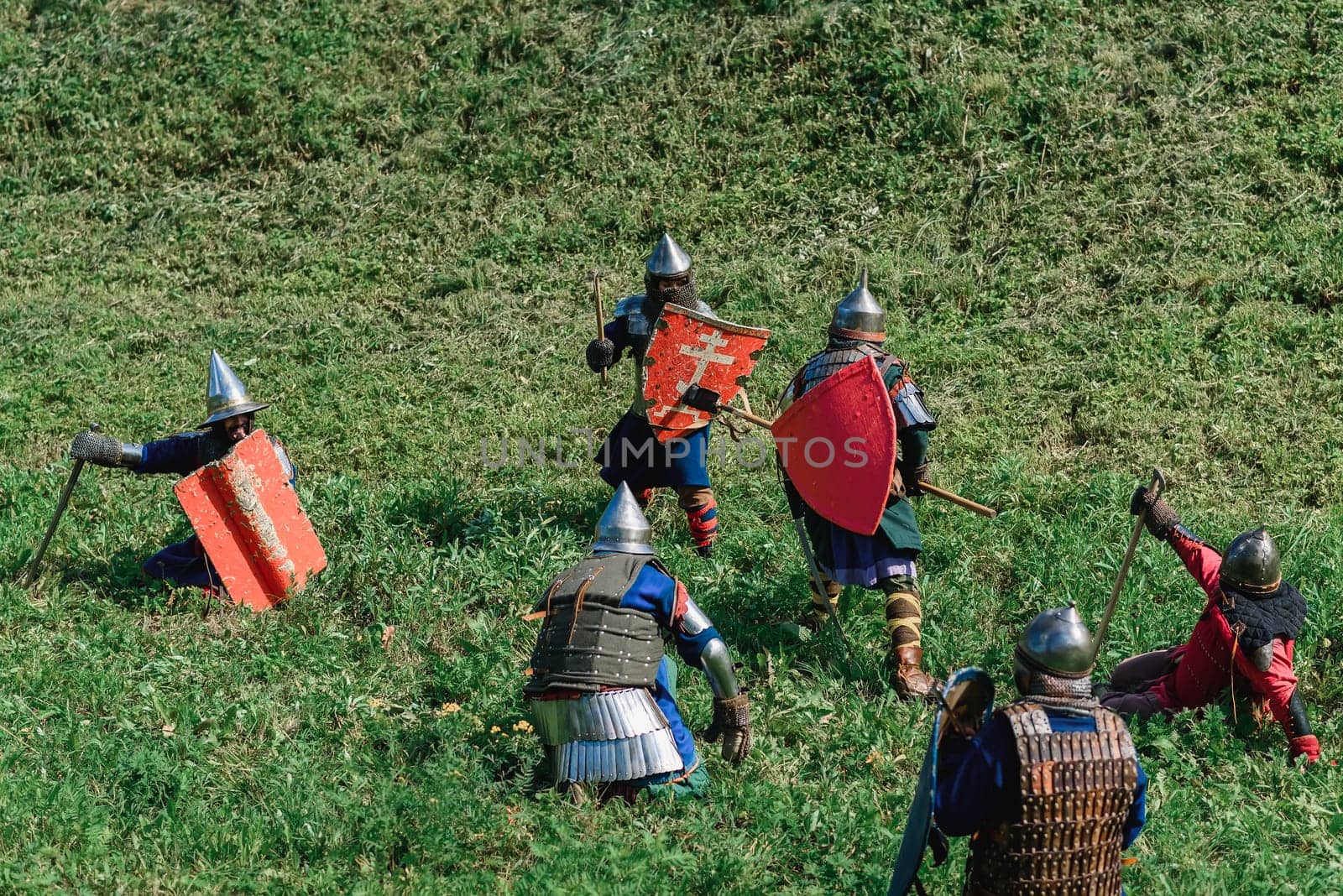 LUH, RUSSIA - AUGUST 27, 2016: Reconstruction of medieval battle of knights in armor and weapons at the festival of Onions in the village of Luh