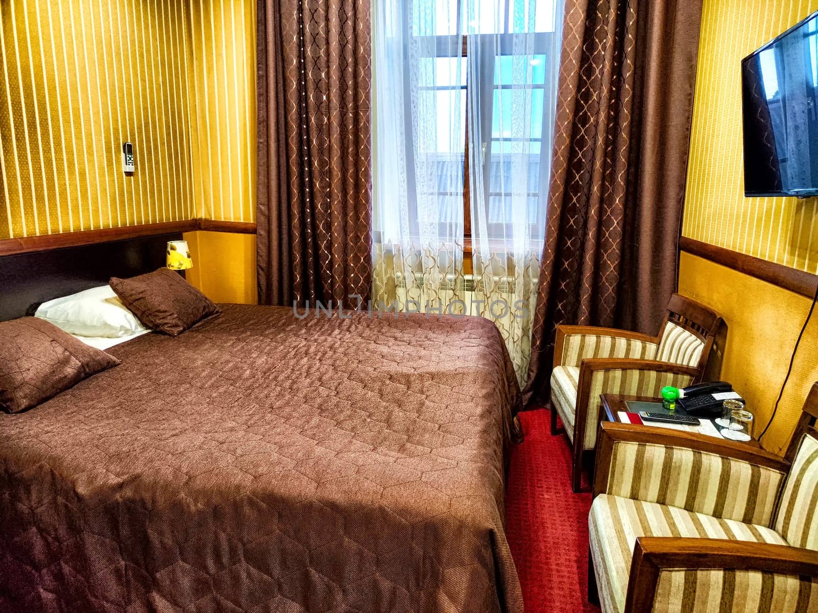 Well-appointed hotel room with plush bedding and classic design.
