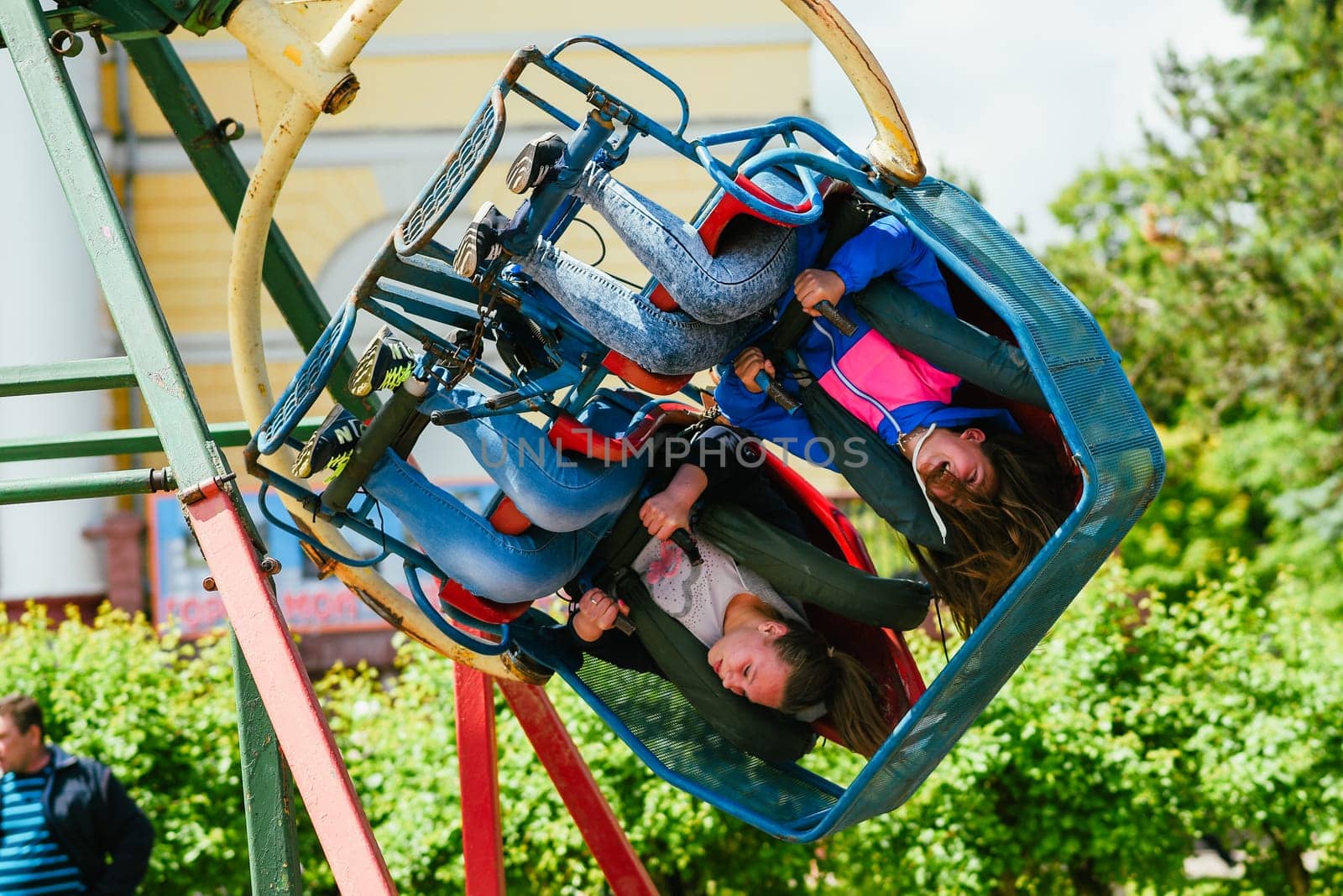 VICHUGA, RUSSIA - JUNE 24, 2017: Two girls ride a carousel in the Park on the Day of Vichuga, Russia
