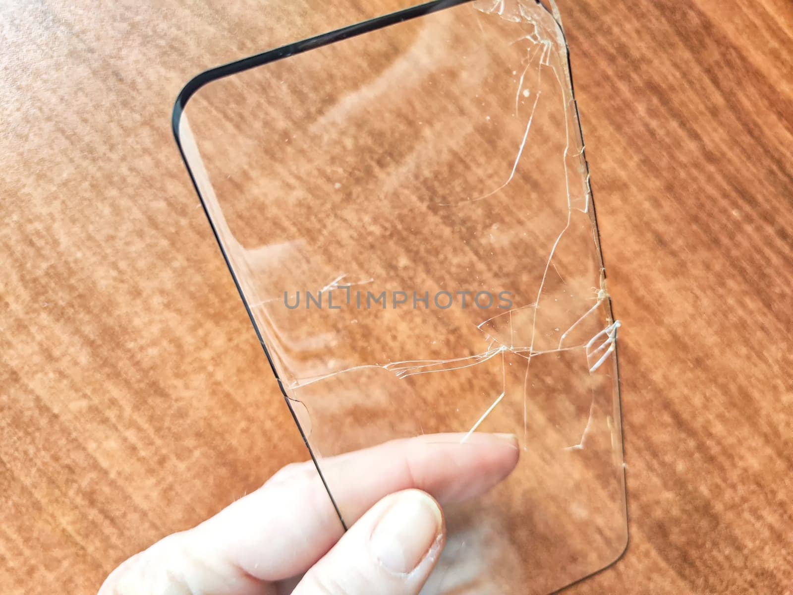 Removing Protective Film From a Cracked Screen. Peeling off a cracked screen protector from a phone by keleny