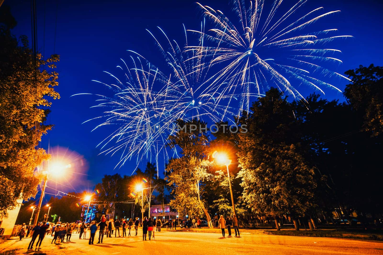 VICHUGA, RUSSIA - JUNE 24, 2017: Festive fireworks and a crowd of people at the Festival of the Day of Vichuga. Russia