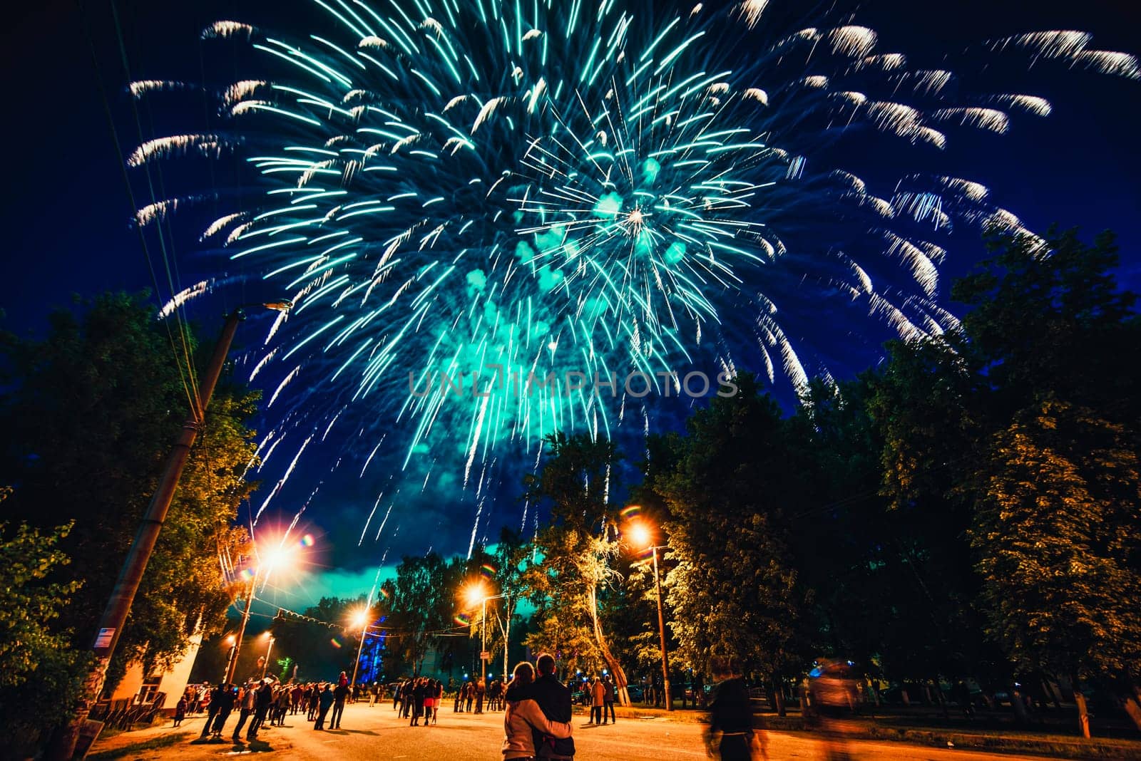 VICHUGA, RUSSIA - JUNE 24, 2017: Festive fireworks and a crowd of people at the Festival of the Day of Vichuga. Russia