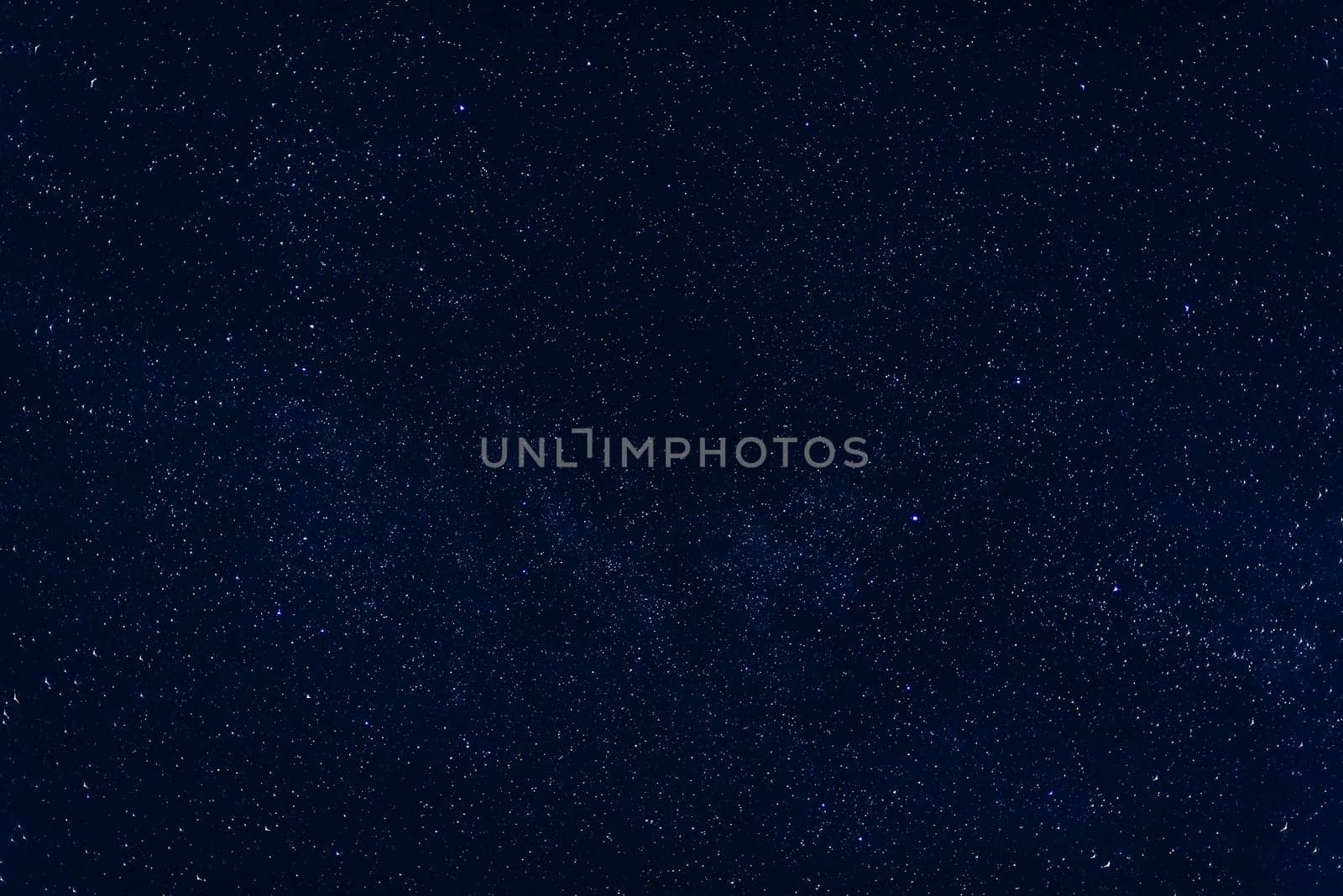 dark blue night sky with the milky way and nebulae