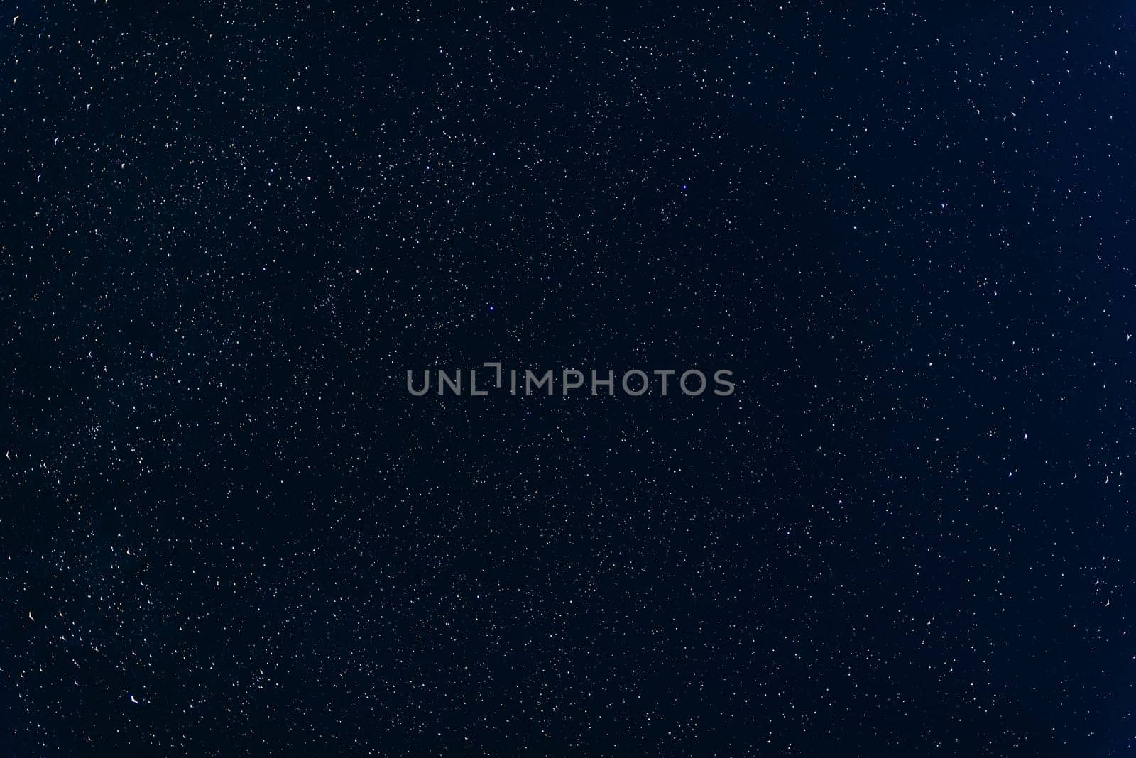 many colorful stars shining in the night dark blue sky with nebulae