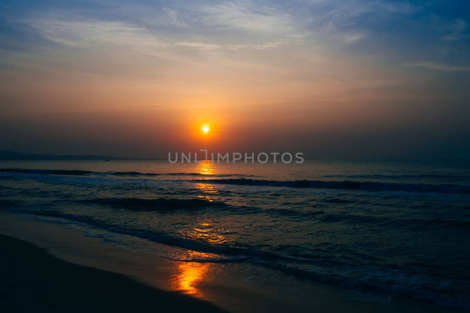 sunrise on the background of blue sky at summer sea