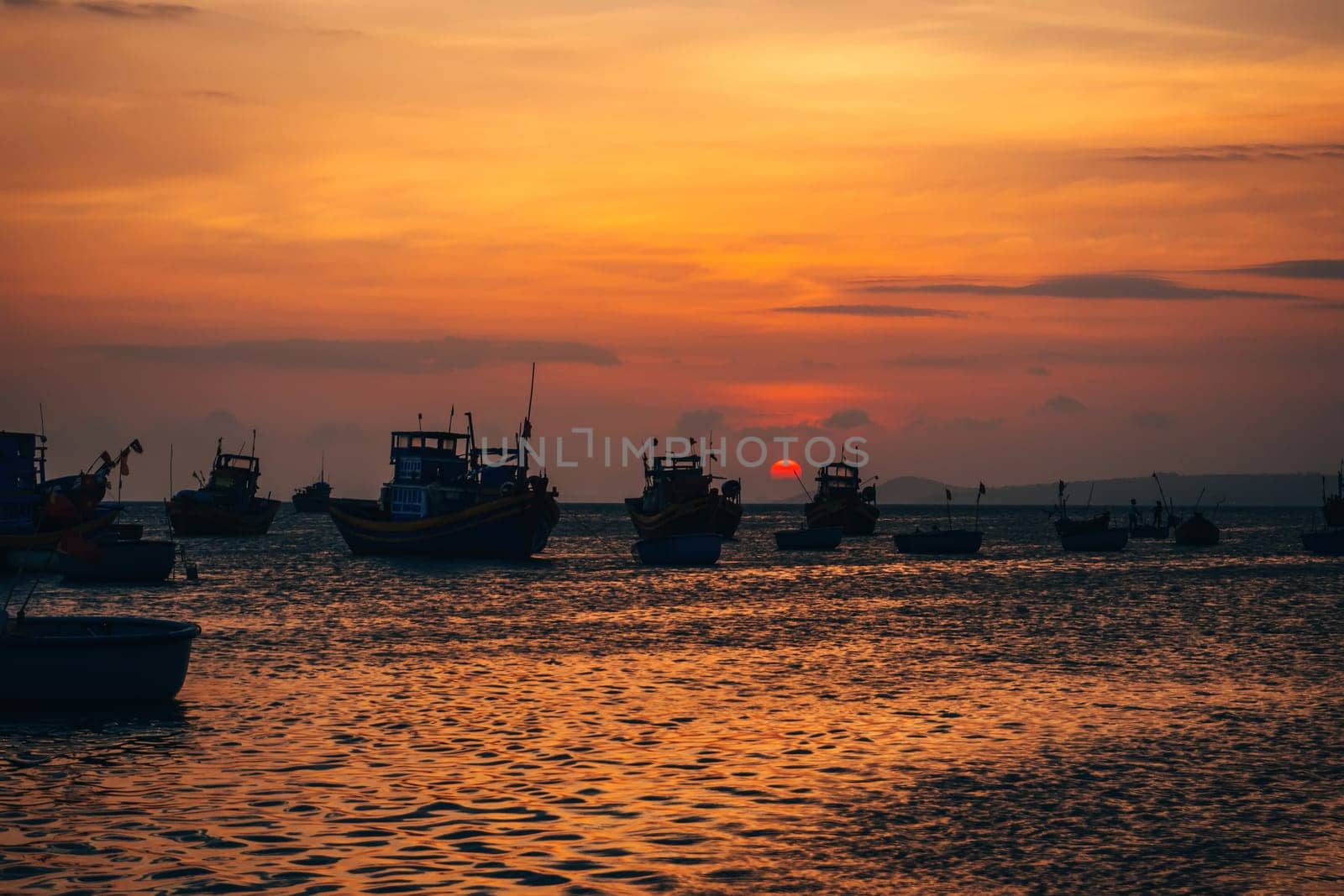 Vietnamese fishing boats in Mui Ne to the sea at sunset