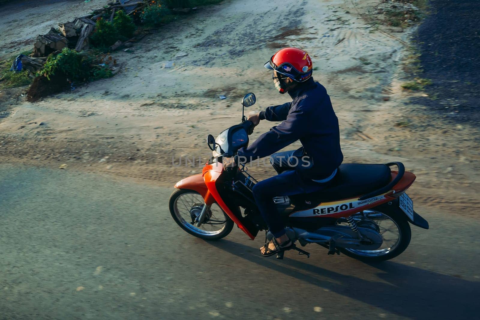 PHAN THIET, VIETNAM - CIRCA MARCH, 2017: A man riding a motorbike on the road