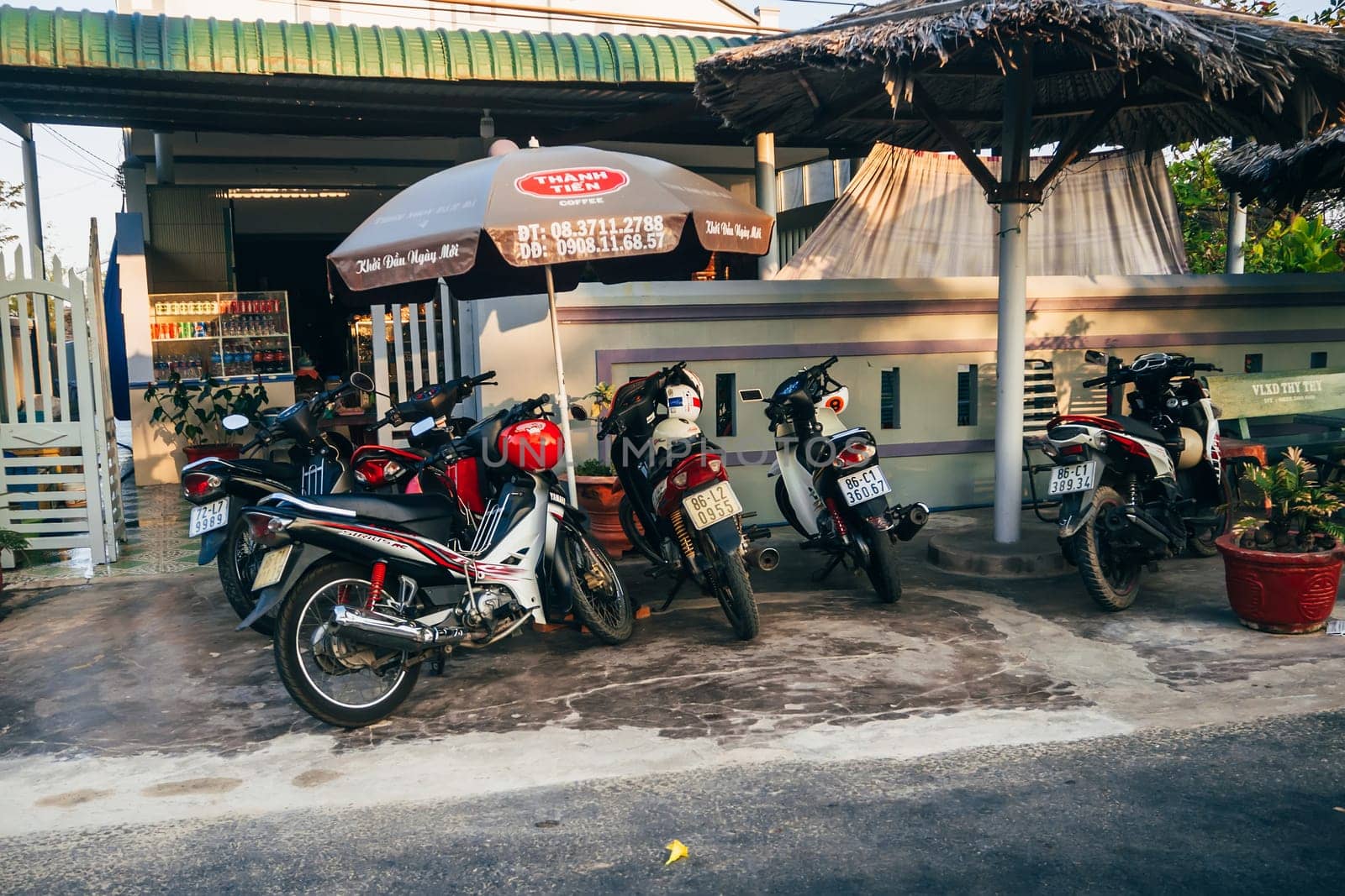 MUI NE, VIETNAM - CIRCA MARCH 2017: A lot of motorbikes standing on the sidewalk