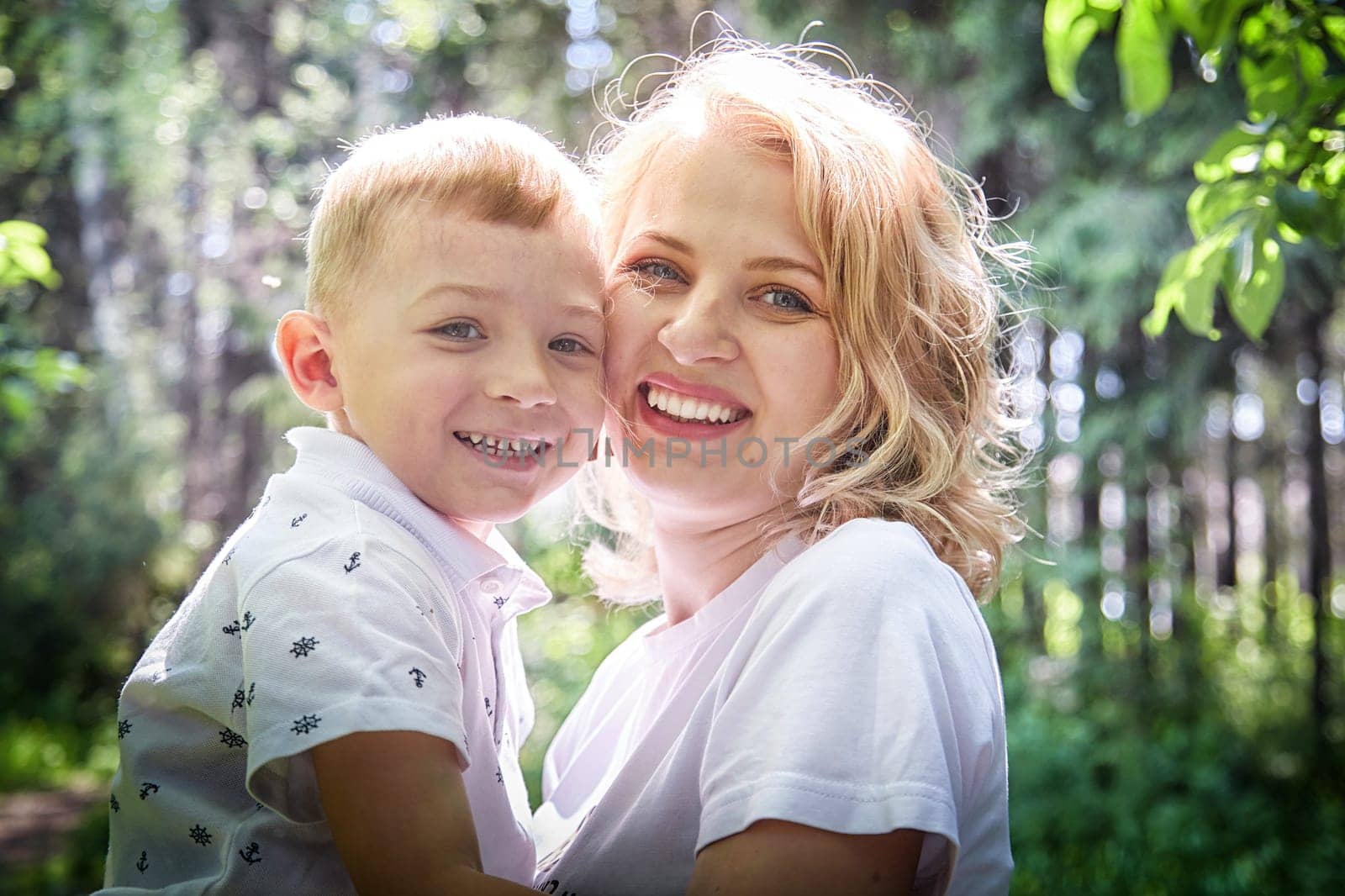 Tender Moment Between Mother and Child in a Sunlit Forest by keleny