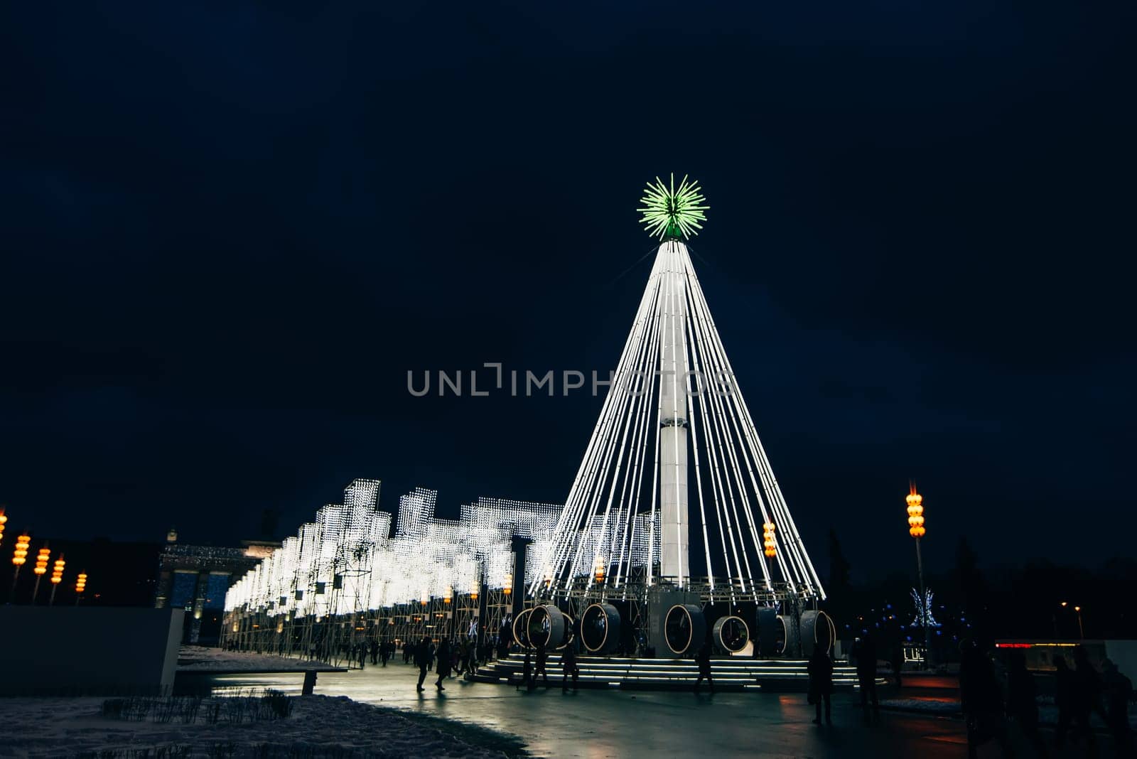 MOSCOW, RUSSIA - DECEMBER 25, 2016: Artificial Christmas fir illuminated at ENEA with visitors to Moscow. Russia
