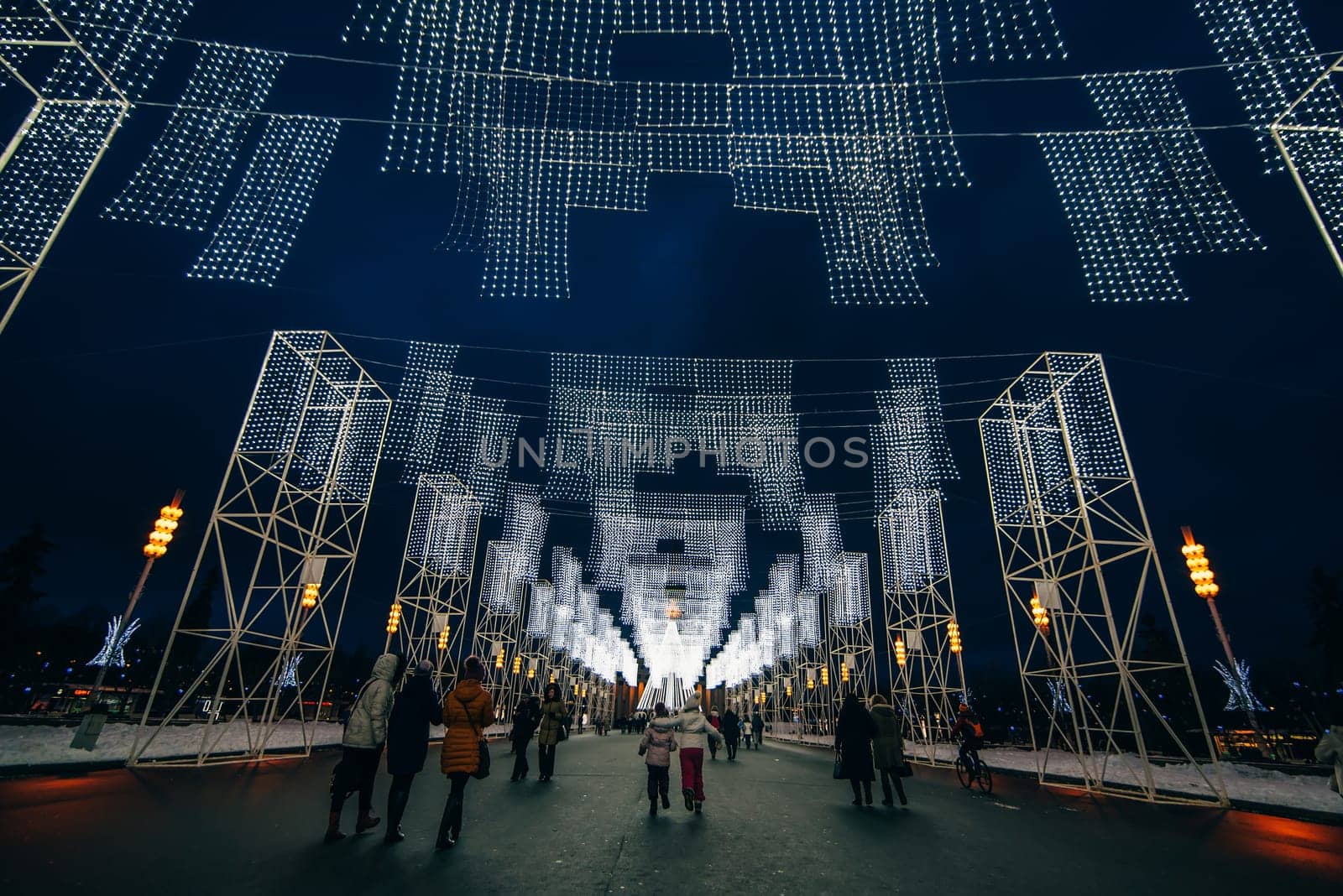 MOSCOW, RUSSIA - DECEMBER 25, 2016: The main alley of VDNKH decorated with Christmas lights the night before the New Year, Moscow. Russia