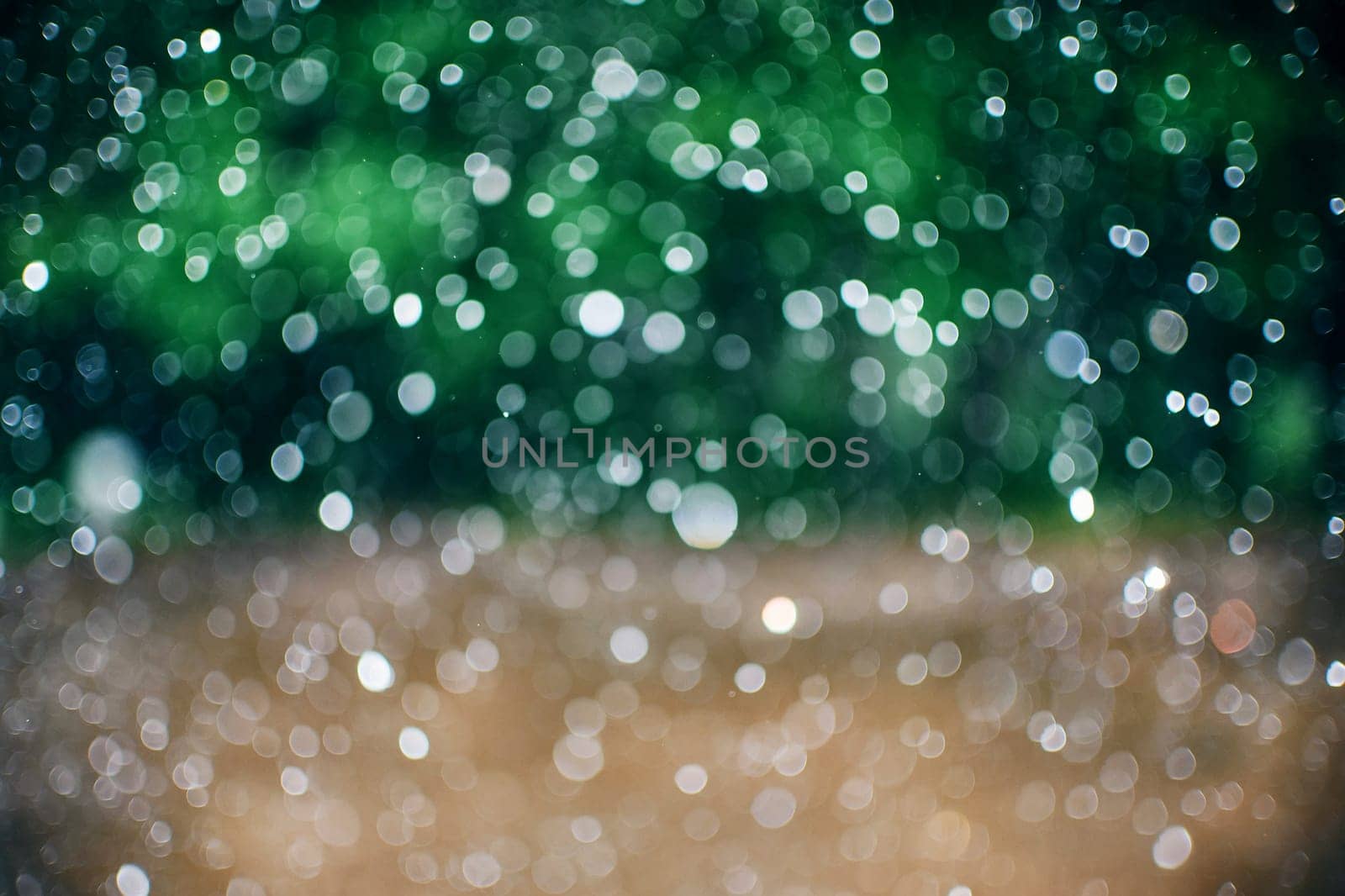 defocused glowing raindrops with blurred abstract green background