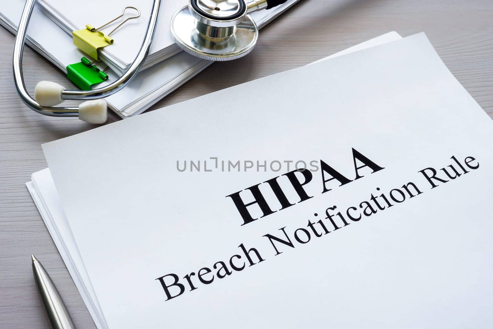 Documents HIPAA breach notification rule on table.