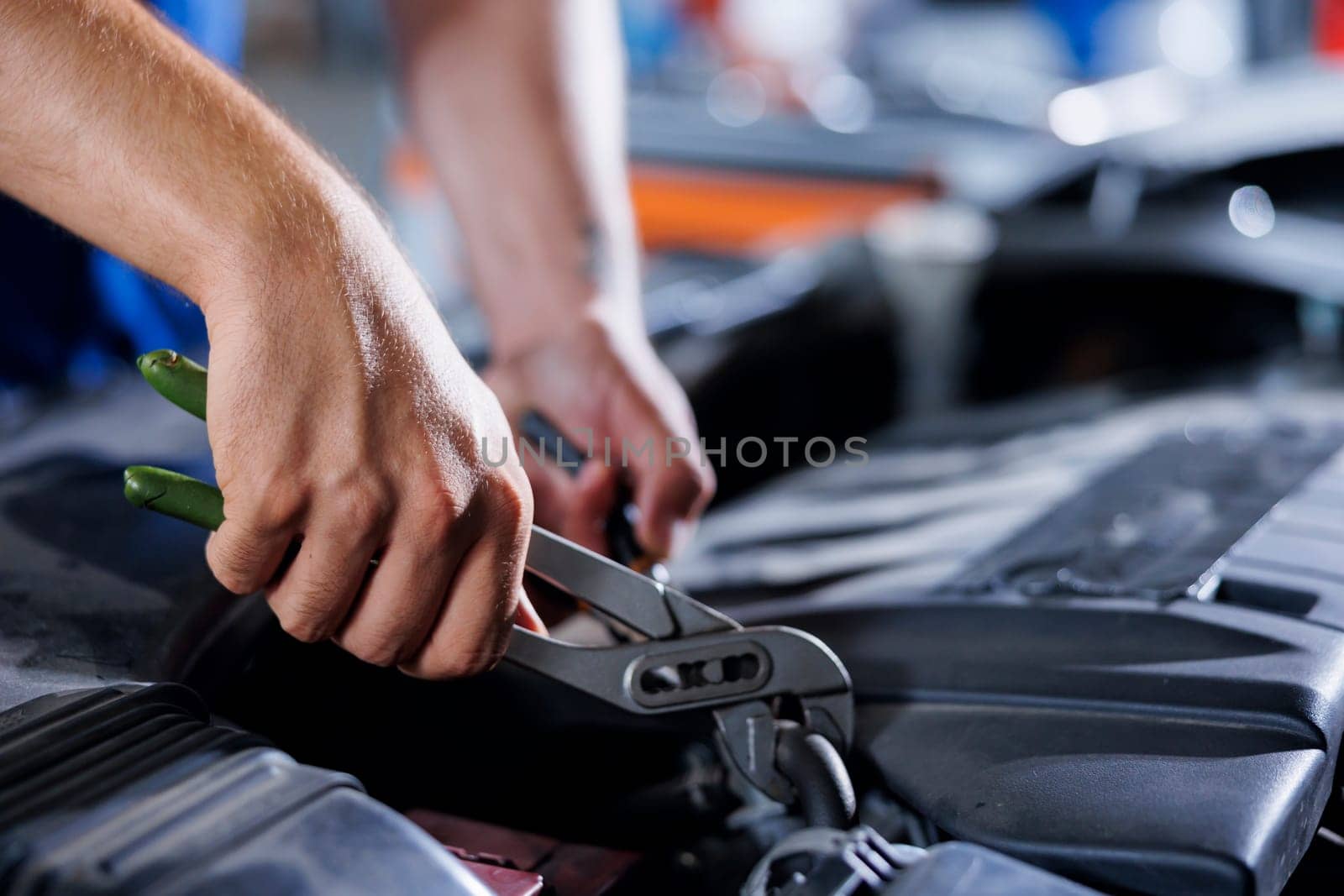 Car service technician expertly examines engine using advanced mechanical tools, ensuring ideal automotive performance and safety. Meticulous garage expert conducts routine vehicle checkup with pliers