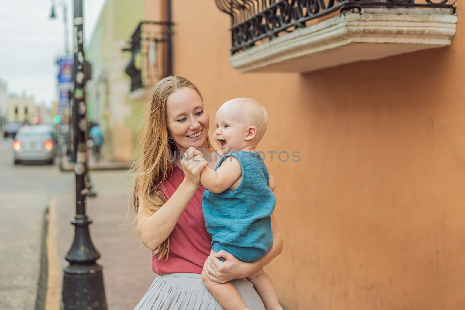 Mother and baby son tourists explore the vibrant streets of Valladolid, Mexico, immersing herself in the rich culture and colorful architecture of this charming colonial town.