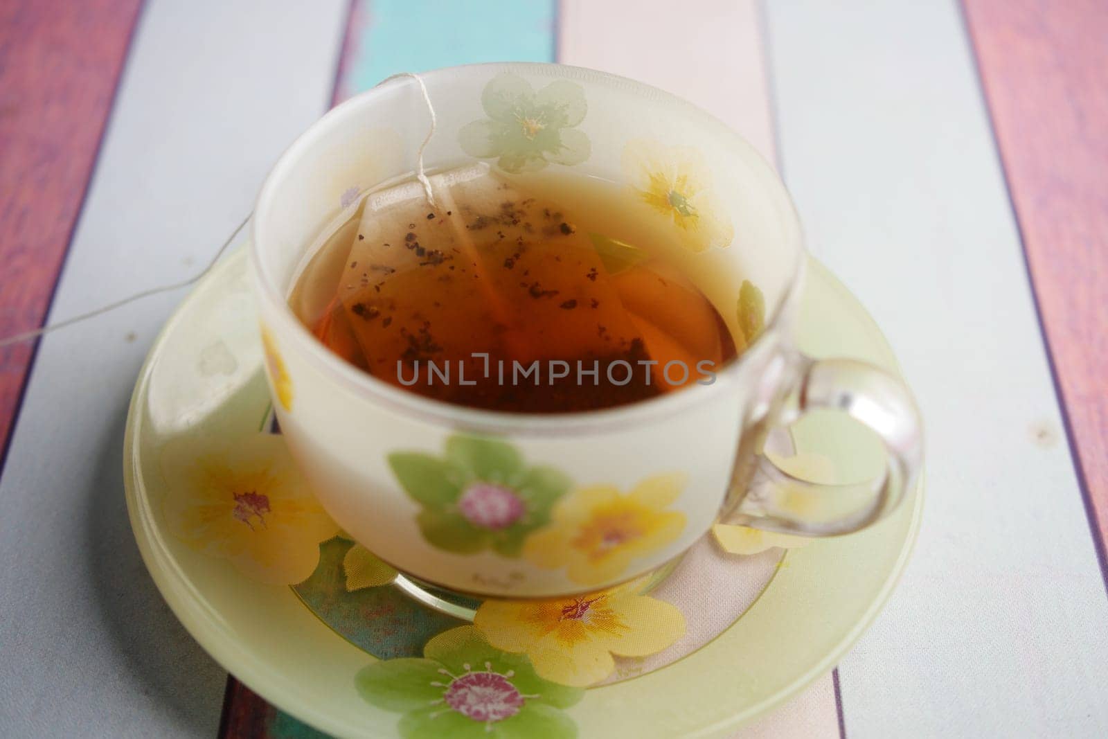 green tea and tea bag on table, close up. by towfiq007