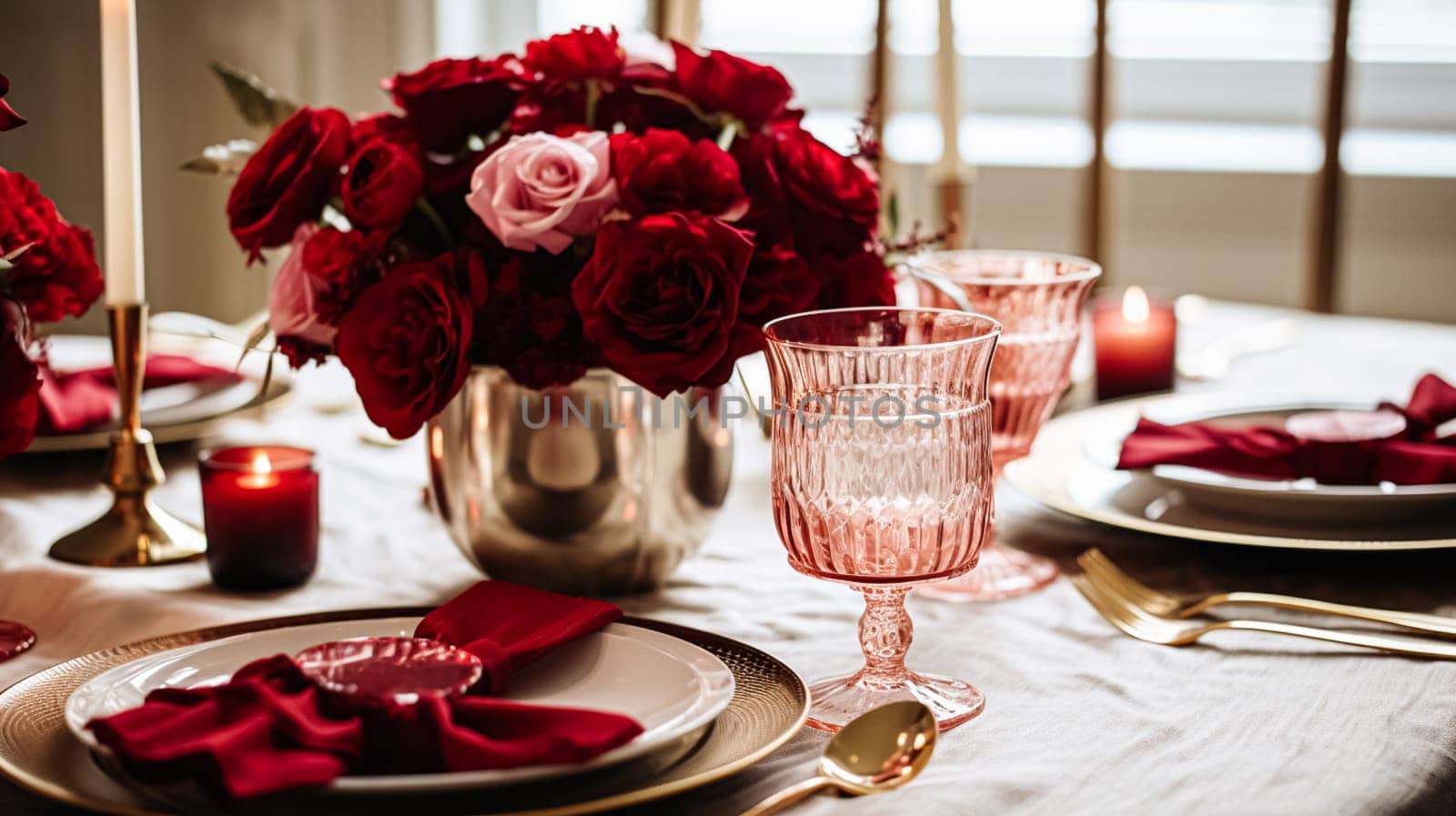 Festive table setting with cutlery, candles and beautiful red flowers by Olayola