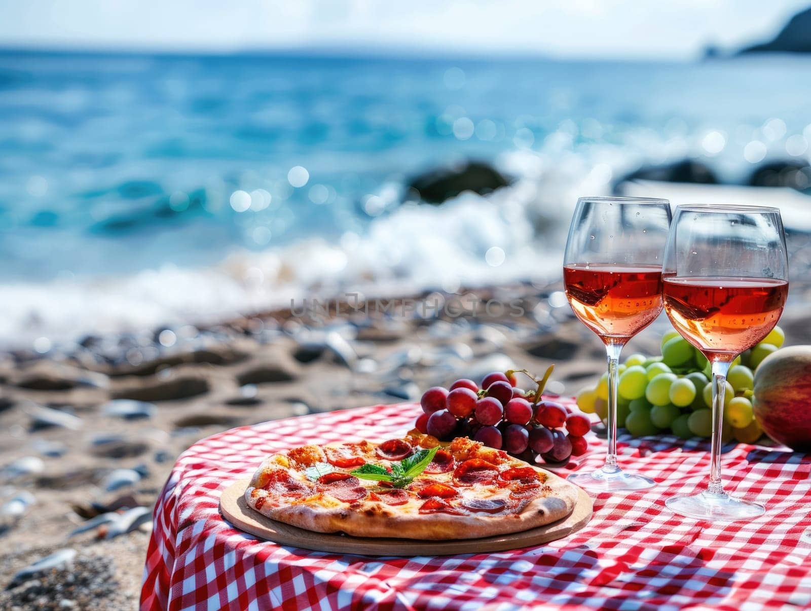 Picnic on the beach at sunset with a spread of fresh fruits, pepperoni pizza, and red wine. Romantic summer dining, food, and wine tasting concept with seaside view. Ai generation. High quality photo