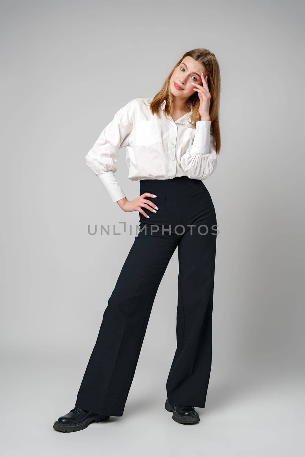Young Woman in White Shirt Posing for Picture in studio