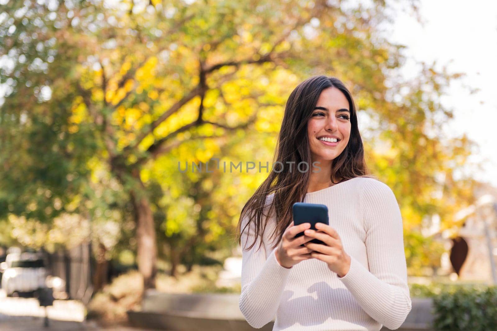 caucasian woman smiling happy using mobile phone by raulmelldo