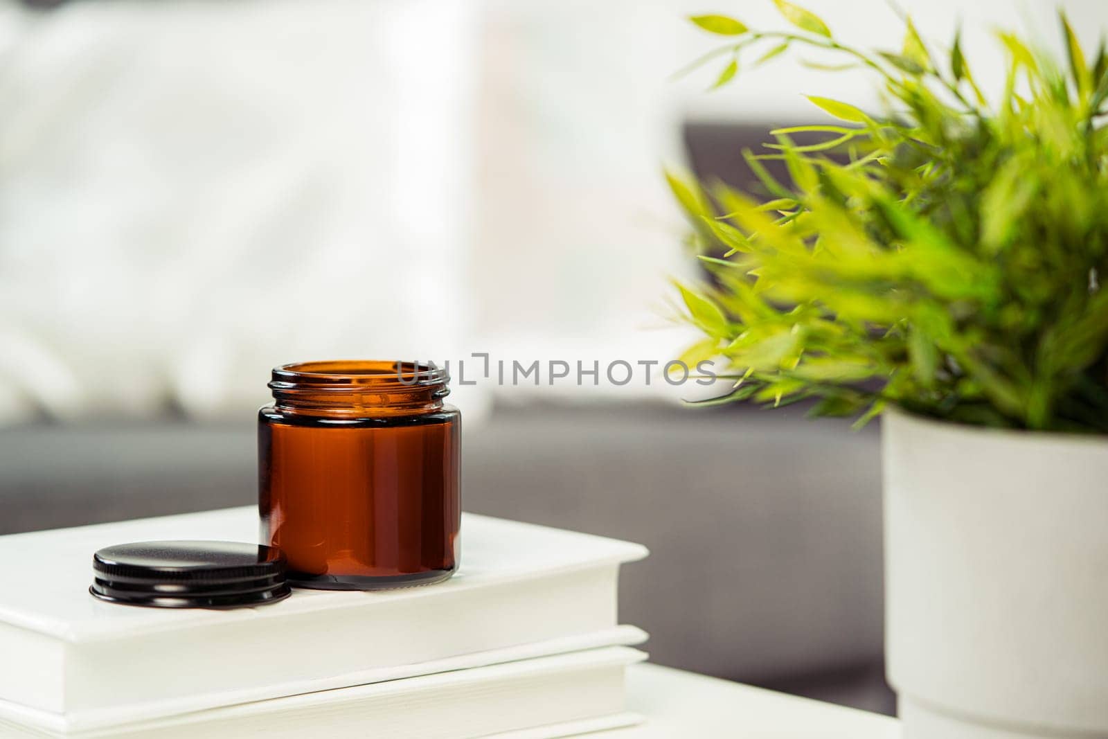 Aromatic candle in glass jar close up photo