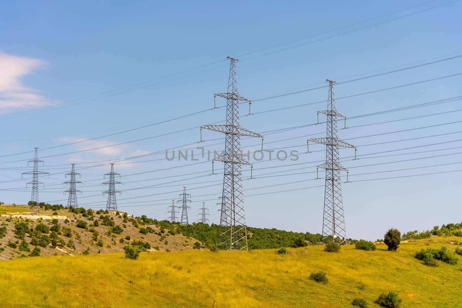 High voltage towers Electric pole. Power line support with wires for electricity transmission. High voltage grid tower with wire cable at distribution station. Energy industry, energy saving by Matiunina