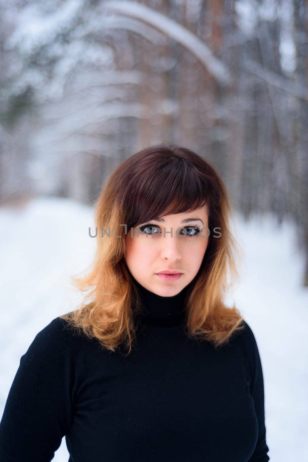portrait of beautiful girl in winter forest