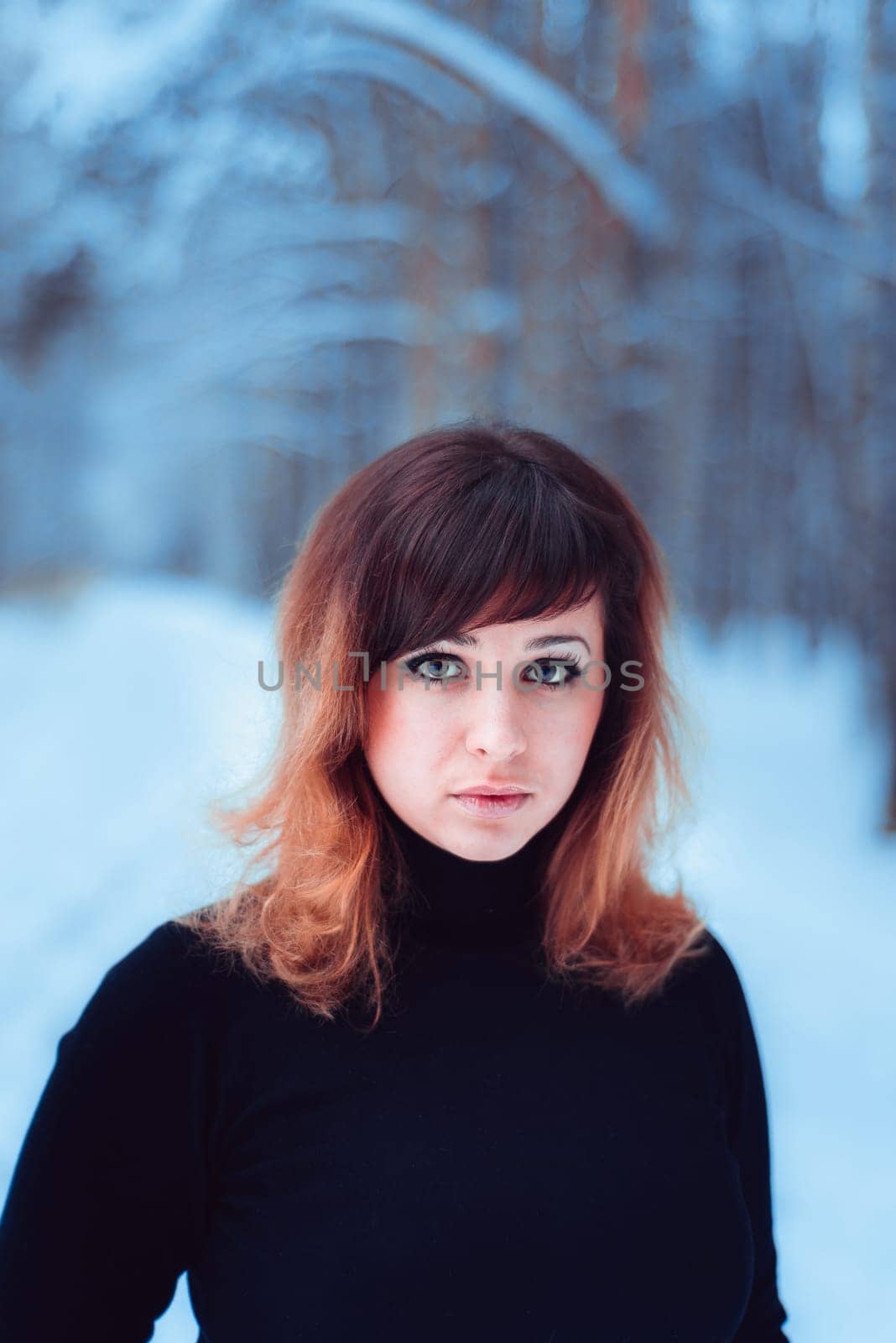 portrait of beautiful girl in winter forest
