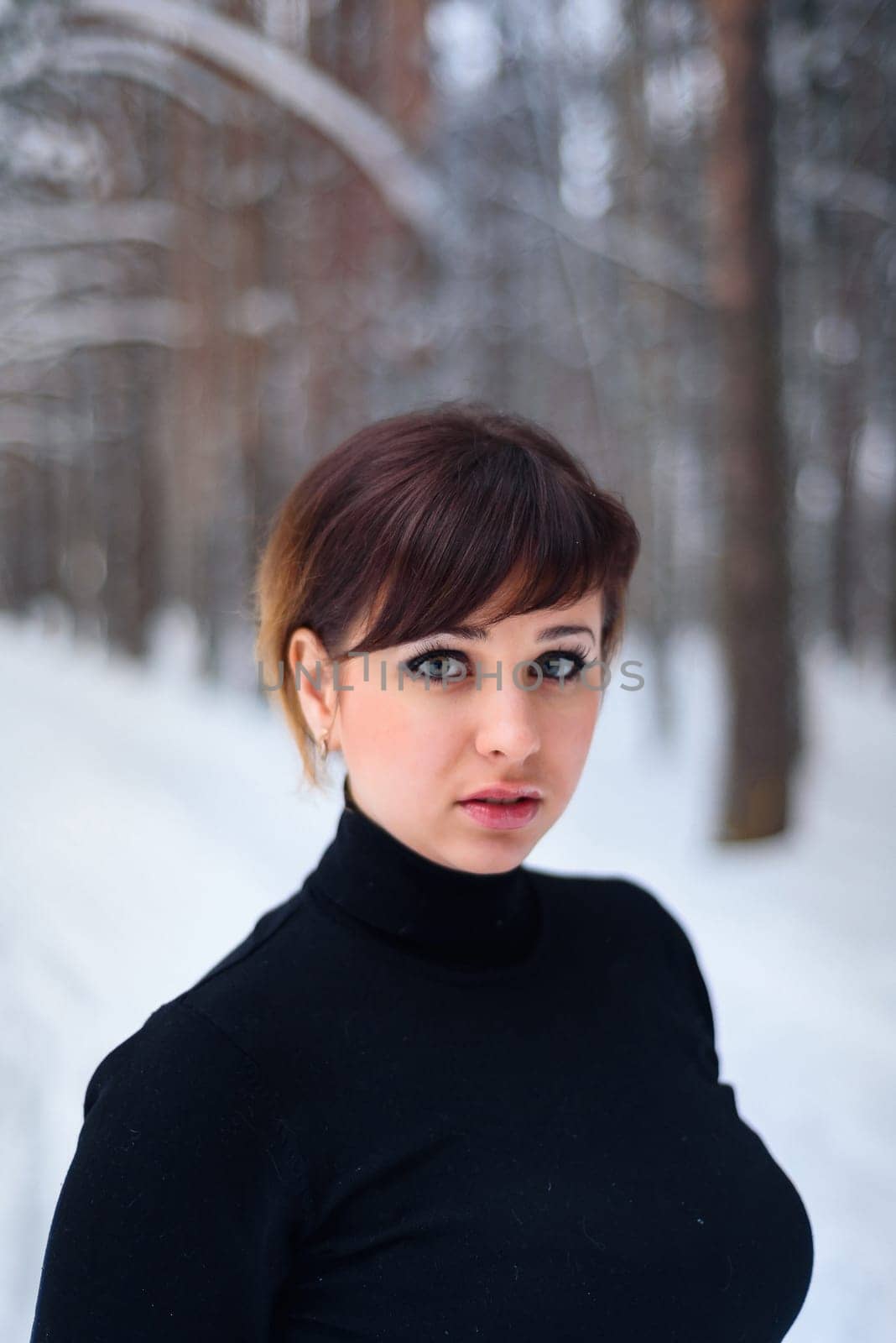 portrait of beautiful girl in winter forest