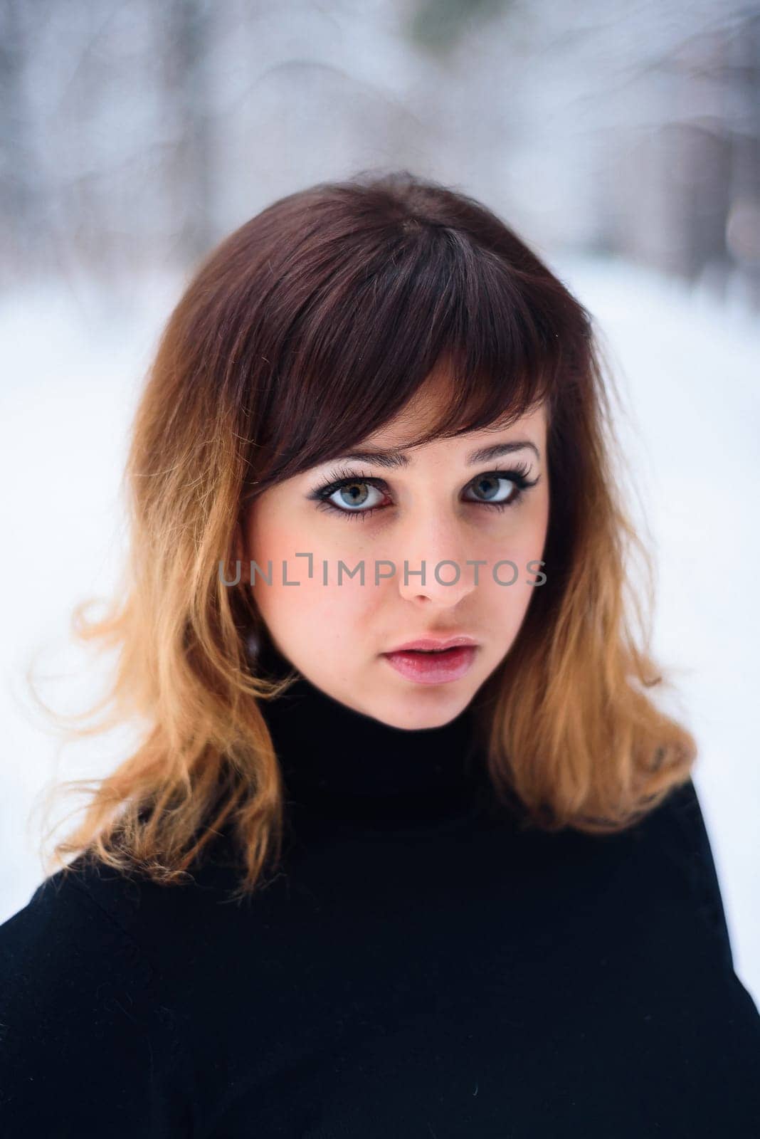 portrait of beautiful girl in winter forest