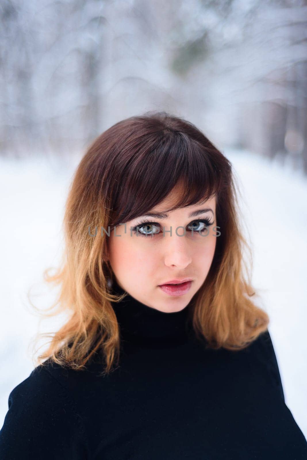 portrait of beautiful girl in winter forest