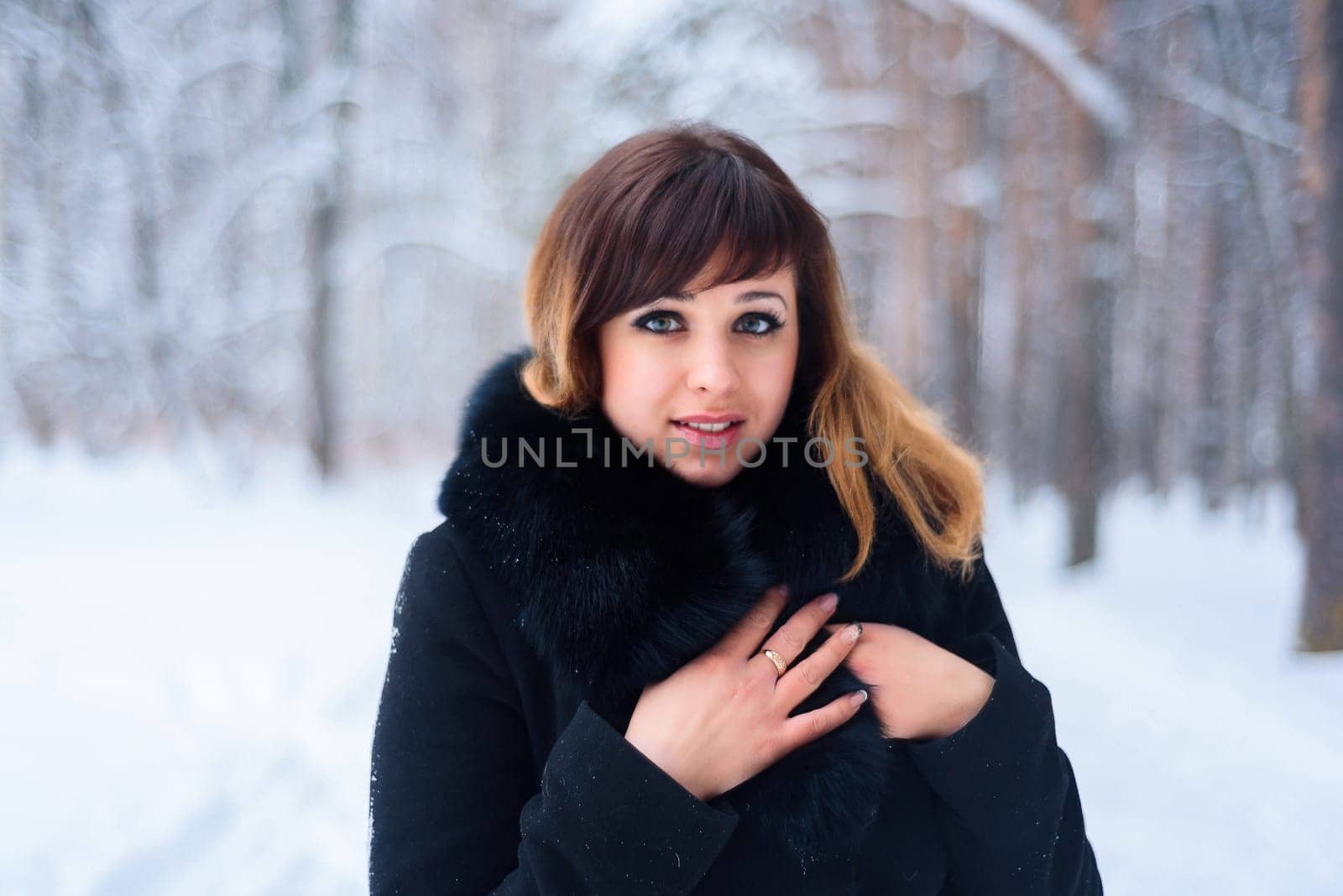 portrait of beautiful girl in winter forest