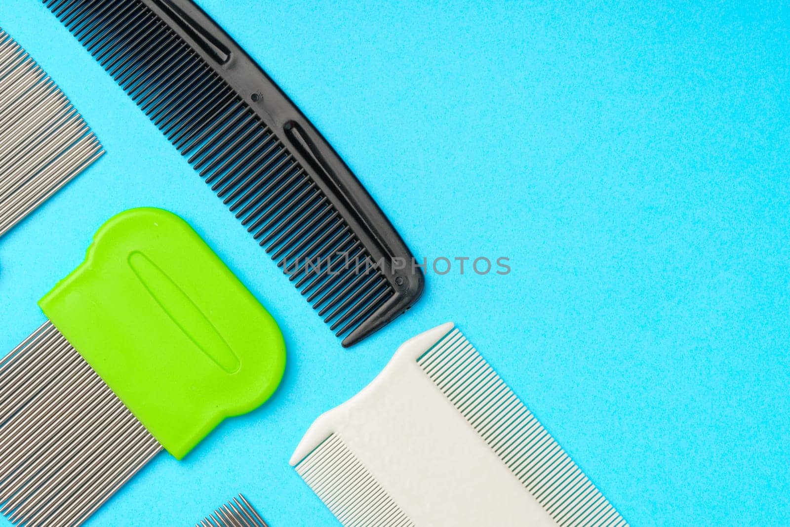 Comb for lice removing on blue background by Fabrikasimf