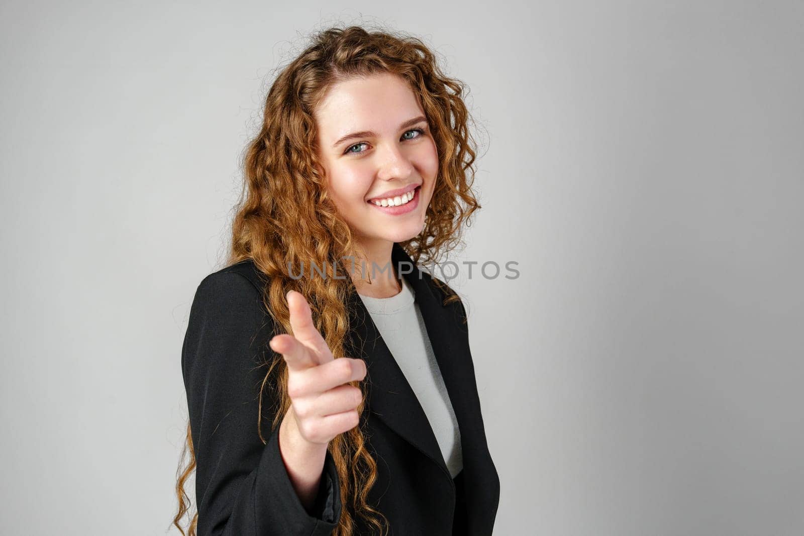 Woman in Black Jacket Pointing at You in Studio