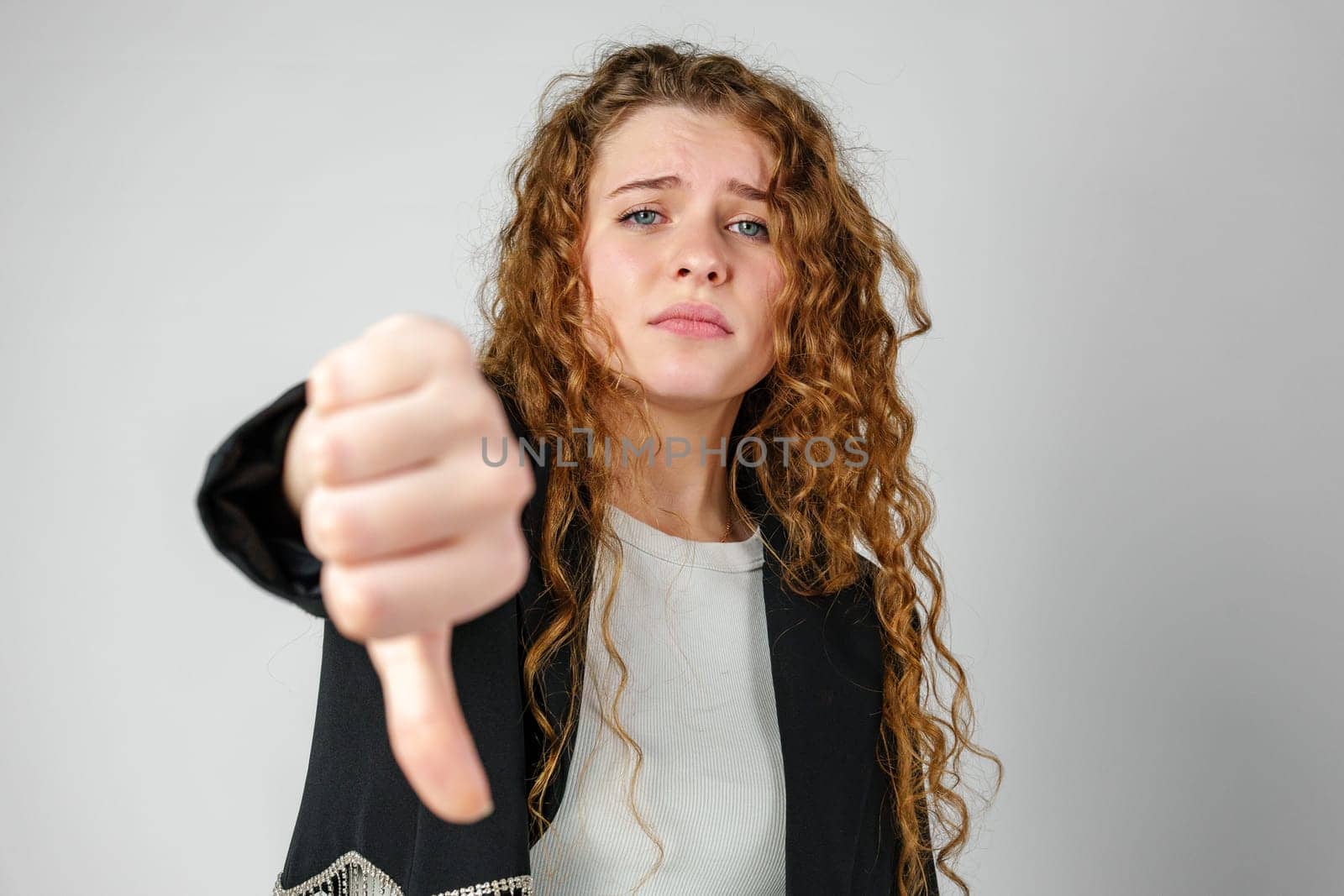 Woman With Curly Hair Giving a Thumbs Down by Fabrikasimf